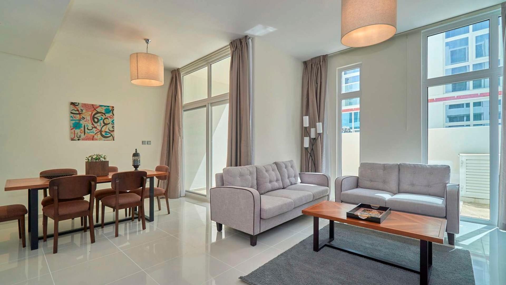 Bright living area in 3-bedroom luxury townhouse, Pacifica, Damac Hills 2, modern furnishings