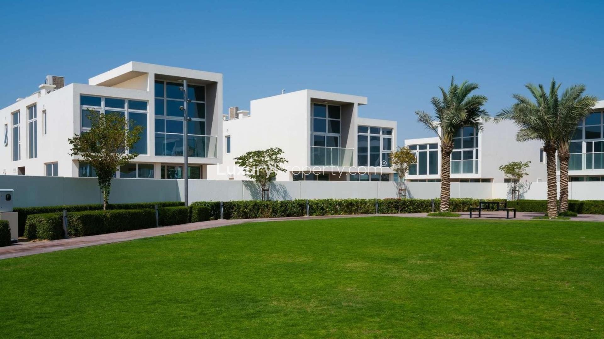 Luxury 3-bedroom townhouse exterior in Avencia, Damac Hills 2, with landscaped garden