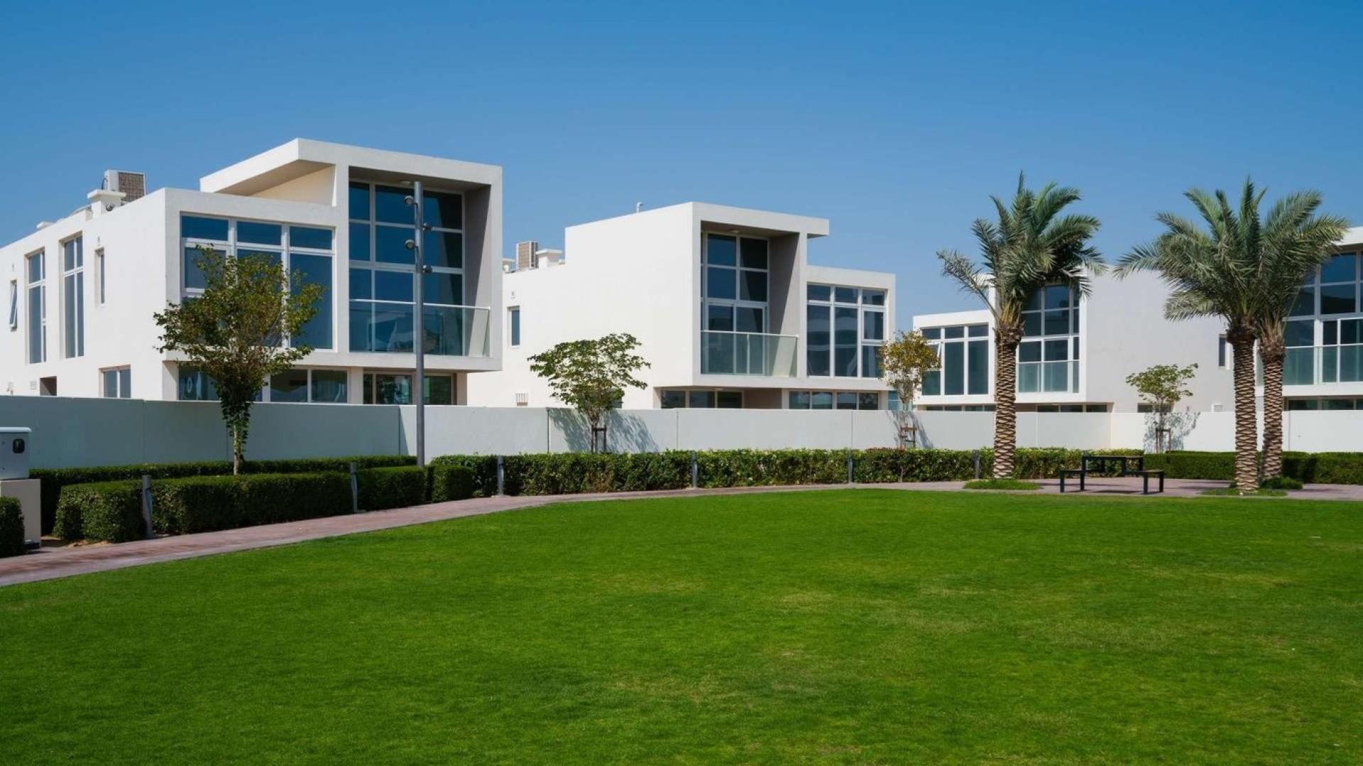 Luxury 3-bedroom townhouse exterior in Avencia, Damac Hills 2, with landscaped garden