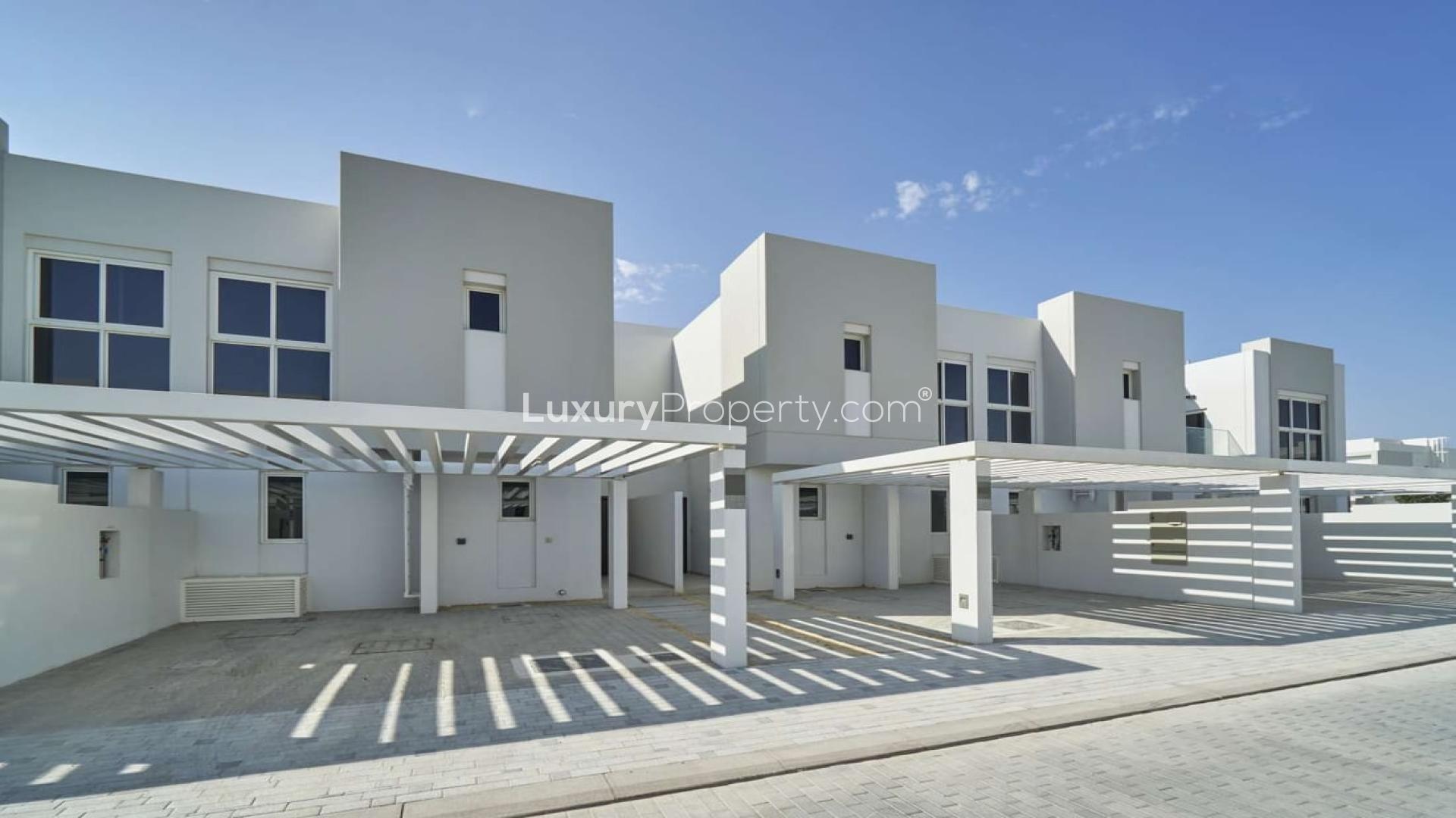 Modern 3-bedroom townhouse exterior in Arabella 3, Mudon with covered parking area