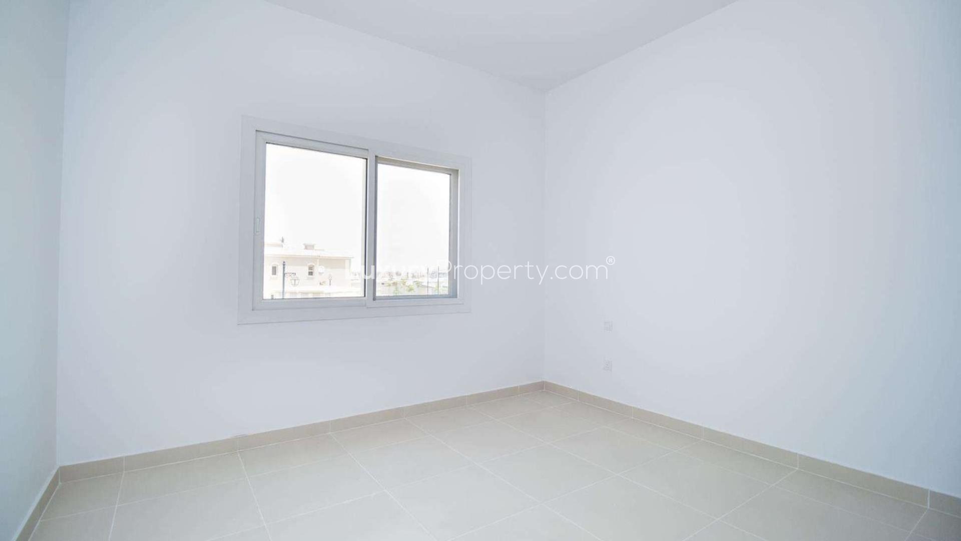 Interior of vacant three-bedroom townhouse in Casa Dora, Serena, featuring modern kitchen and stairs