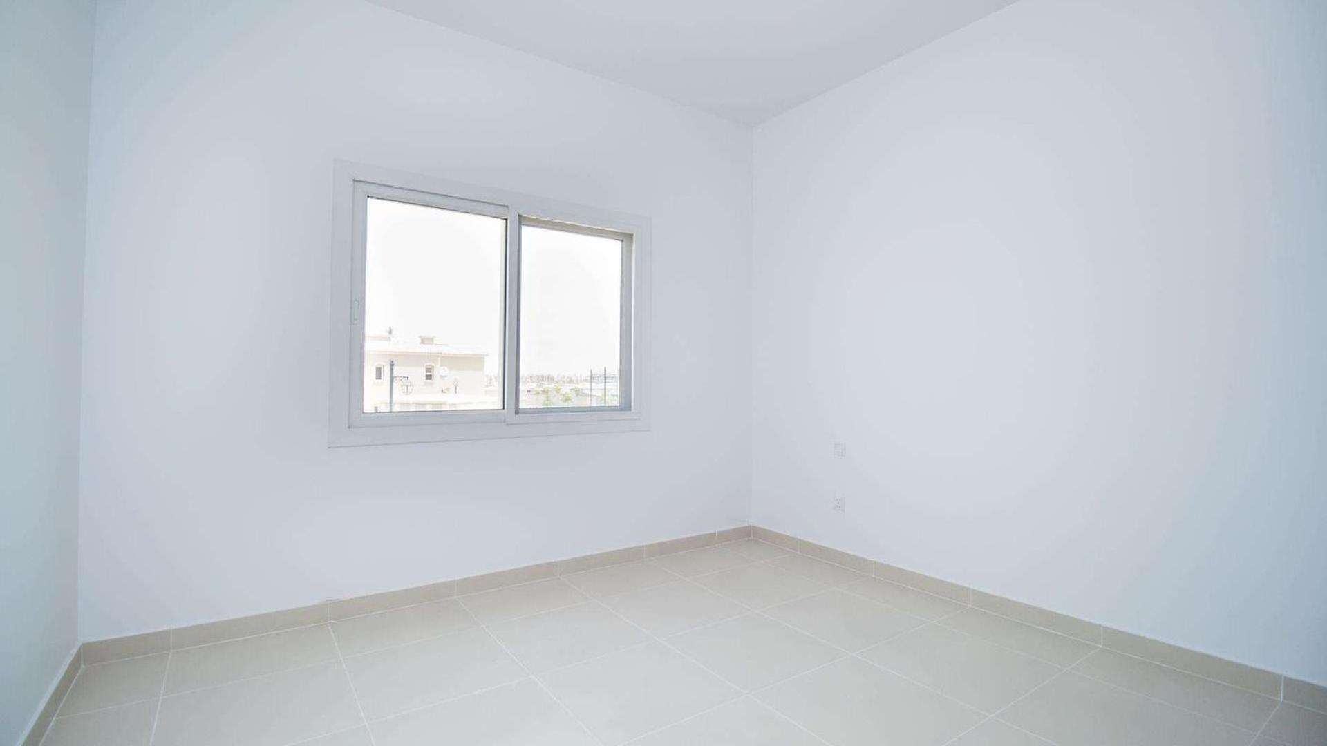 Interior of vacant three-bedroom townhouse in Casa Dora, Serena, featuring modern kitchen and stairs