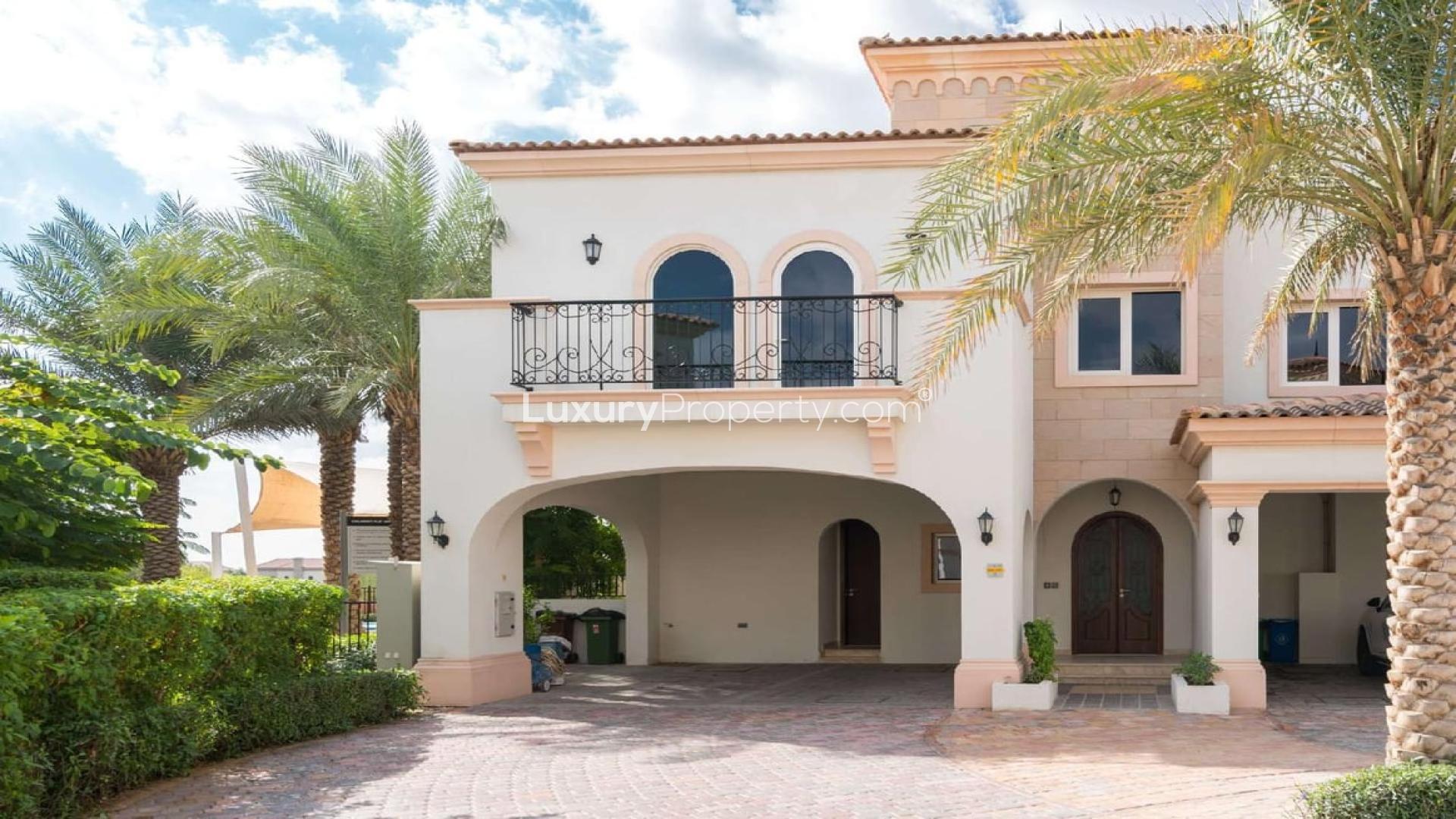 Stylish Mediterranean townhouse exterior in Jumeirah Golf Estates, lush landscaping, spacious driveway