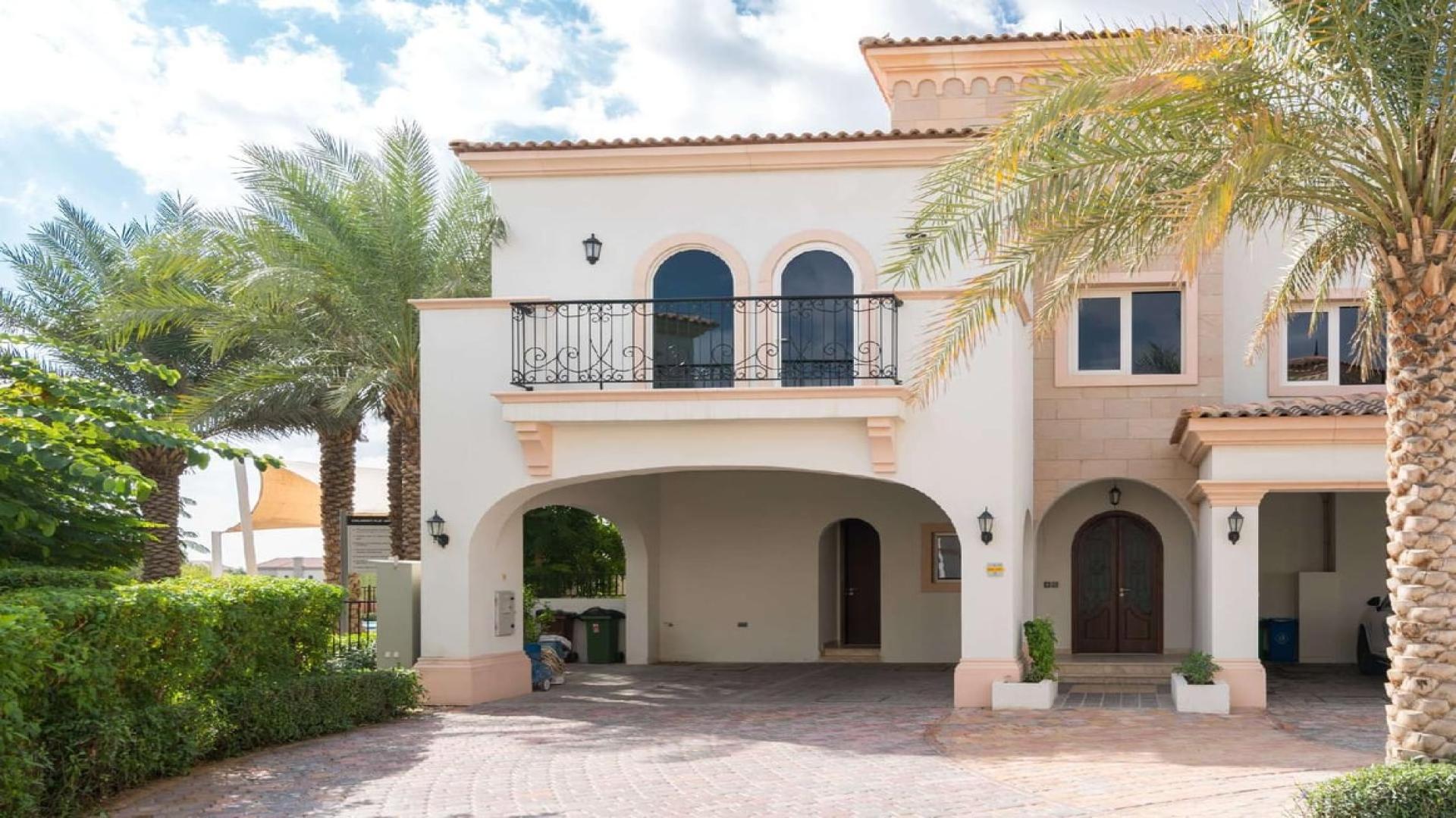 Stylish Mediterranean townhouse exterior in Jumeirah Golf Estates, lush landscaping, spacious driveway