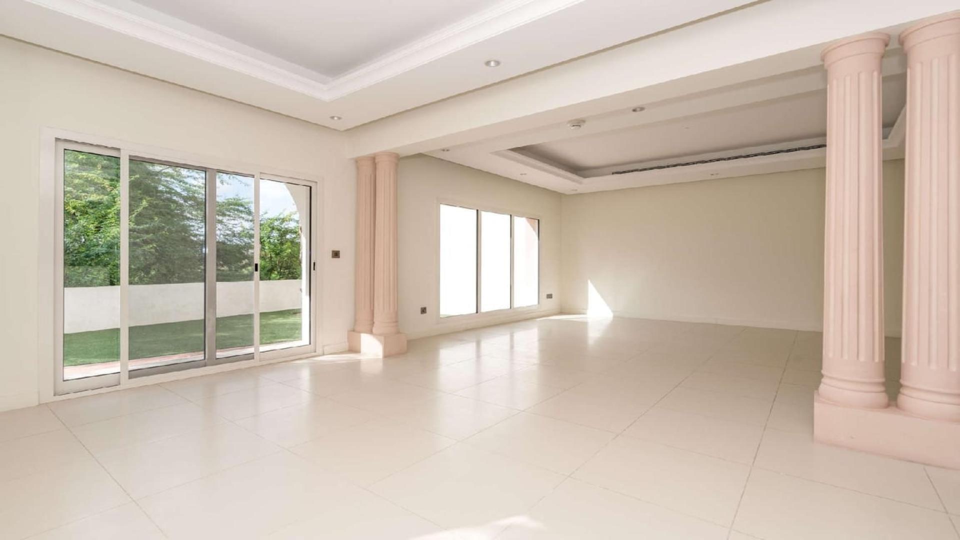 Spacious living room with large windows in Jumeirah Golf Estates townhouse, Fire community