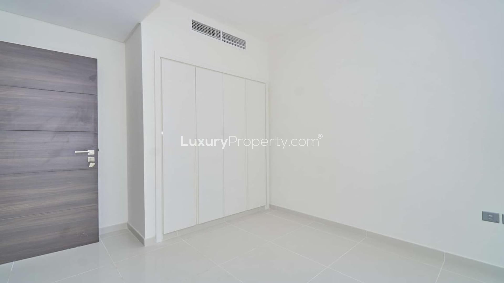 Empty room with wooden door and built-in closet in Albizia, Damac Hills 2 townhouse