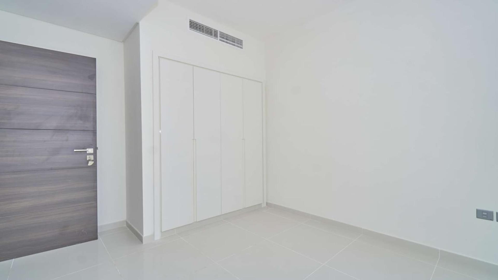 Empty room with wooden door and built-in closet in Albizia, Damac Hills 2 townhouse