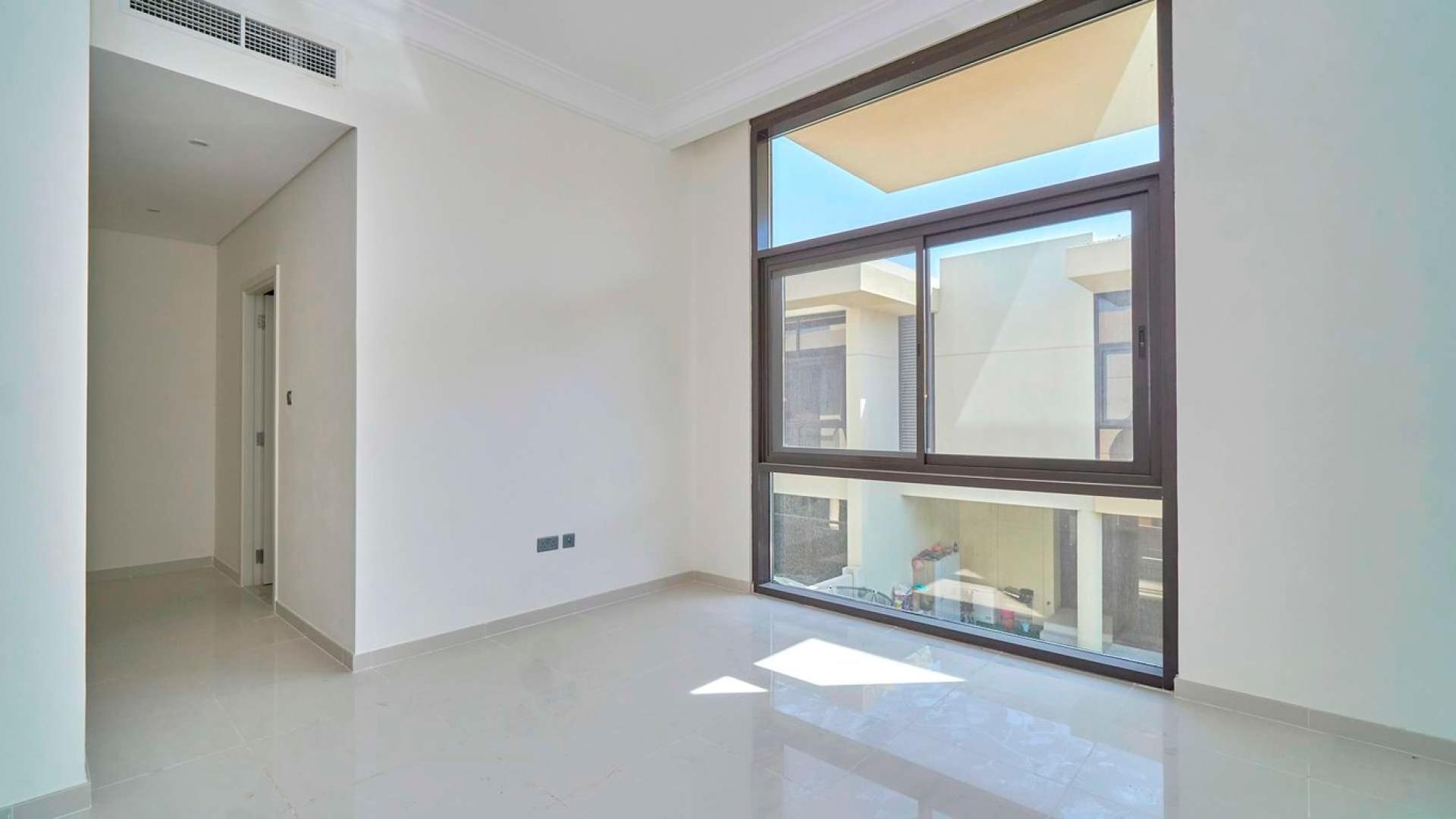 Modern three-bedroom townhouse exterior in Akoya Park, Damac Hills, for sale