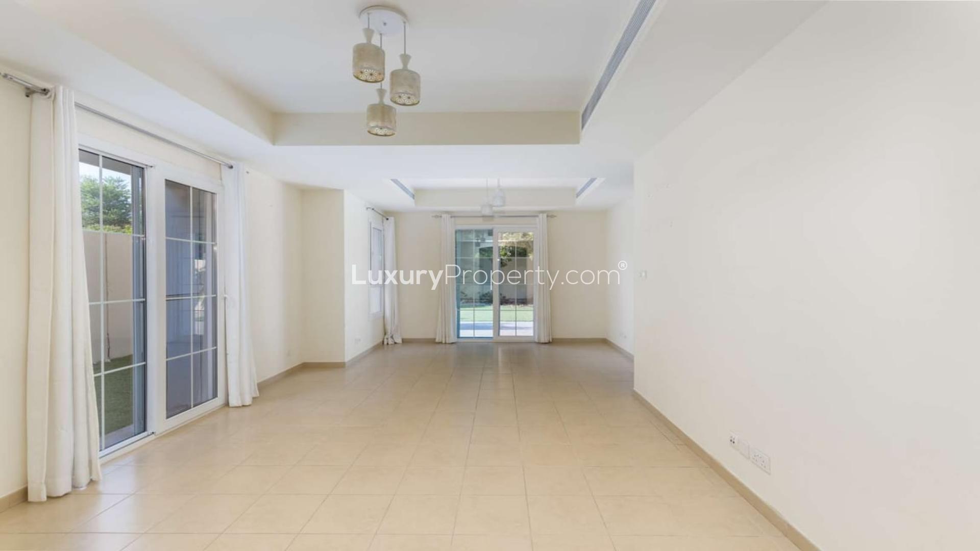 Townhouse exterior with garden in Arabian Ranches, Alma community, for sale