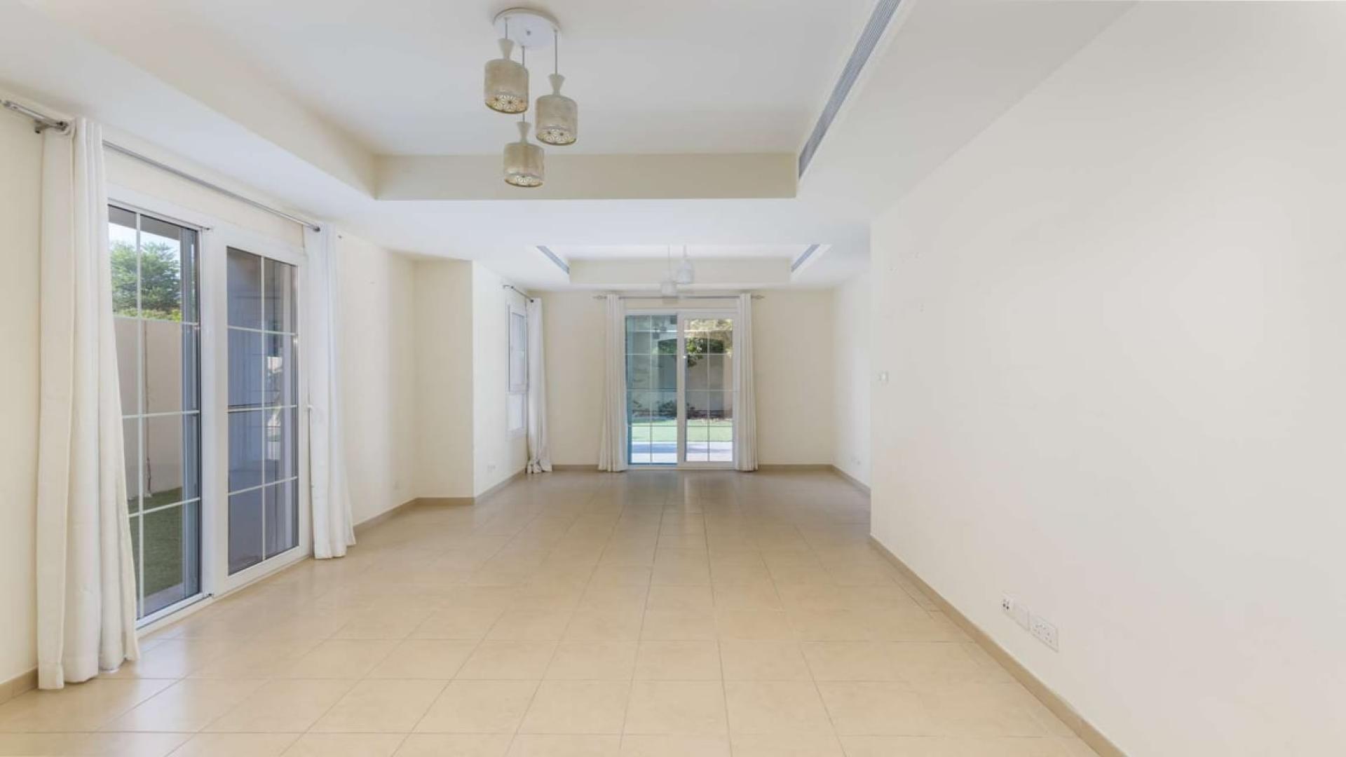 Townhouse exterior with garden in Arabian Ranches, Alma community, for sale