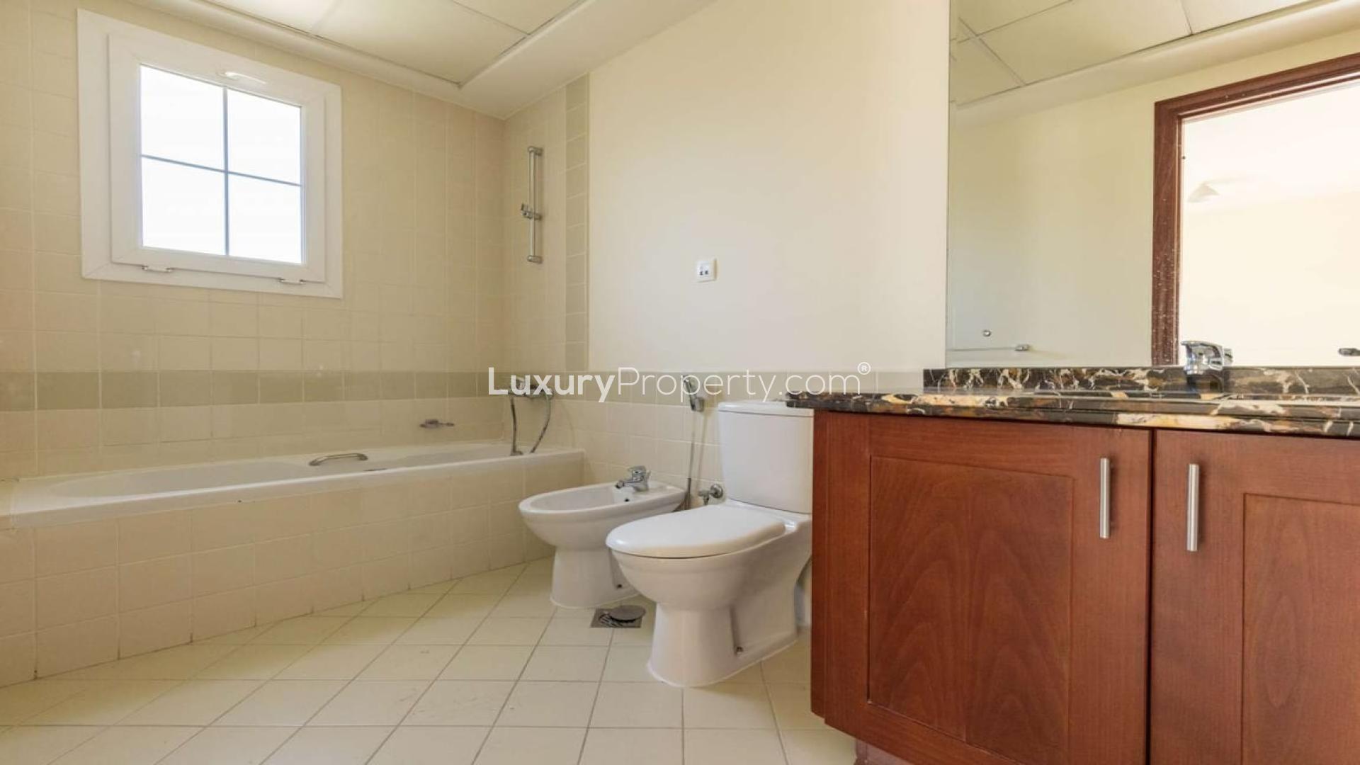 Exterior of 3-bedroom townhouse for sale in Alma, Arabian Ranches, with landscaped garden