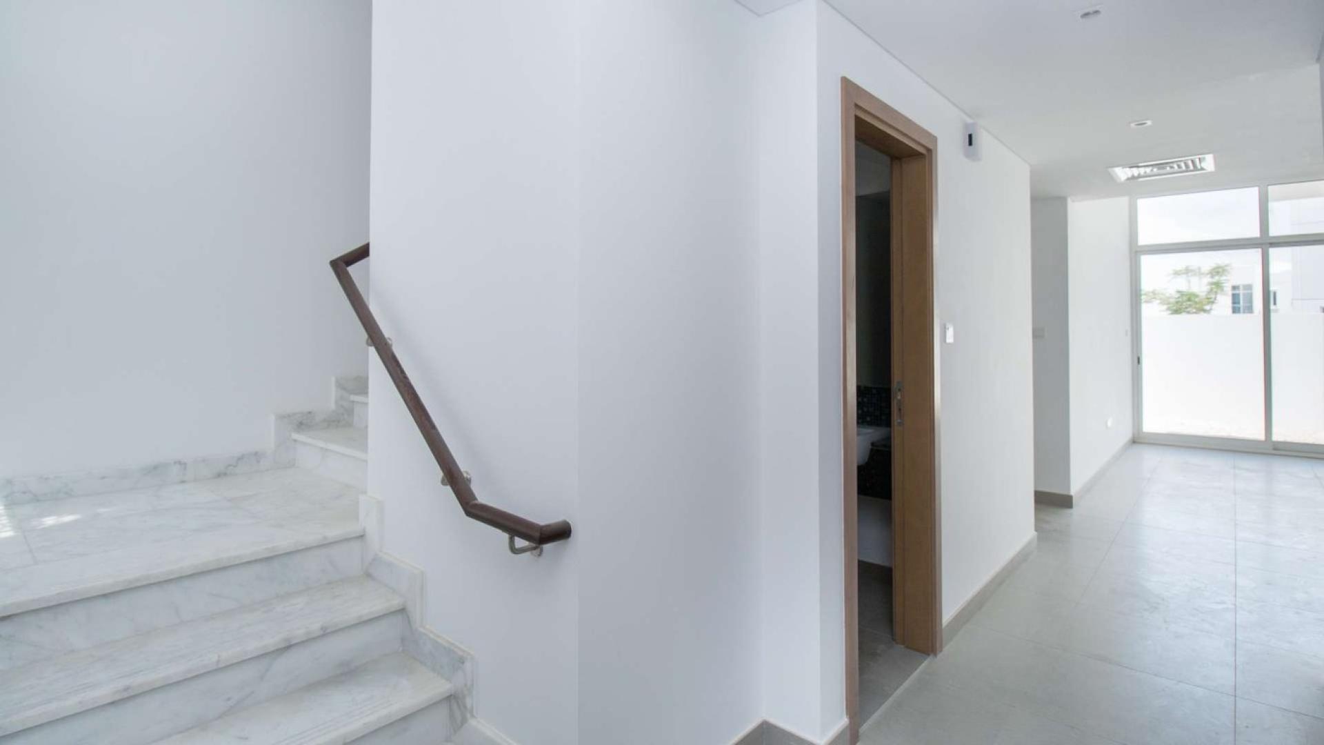 Modern 3-bedroom townhouse facade in Arabella, Mudon, featuring sleek design and private entrance