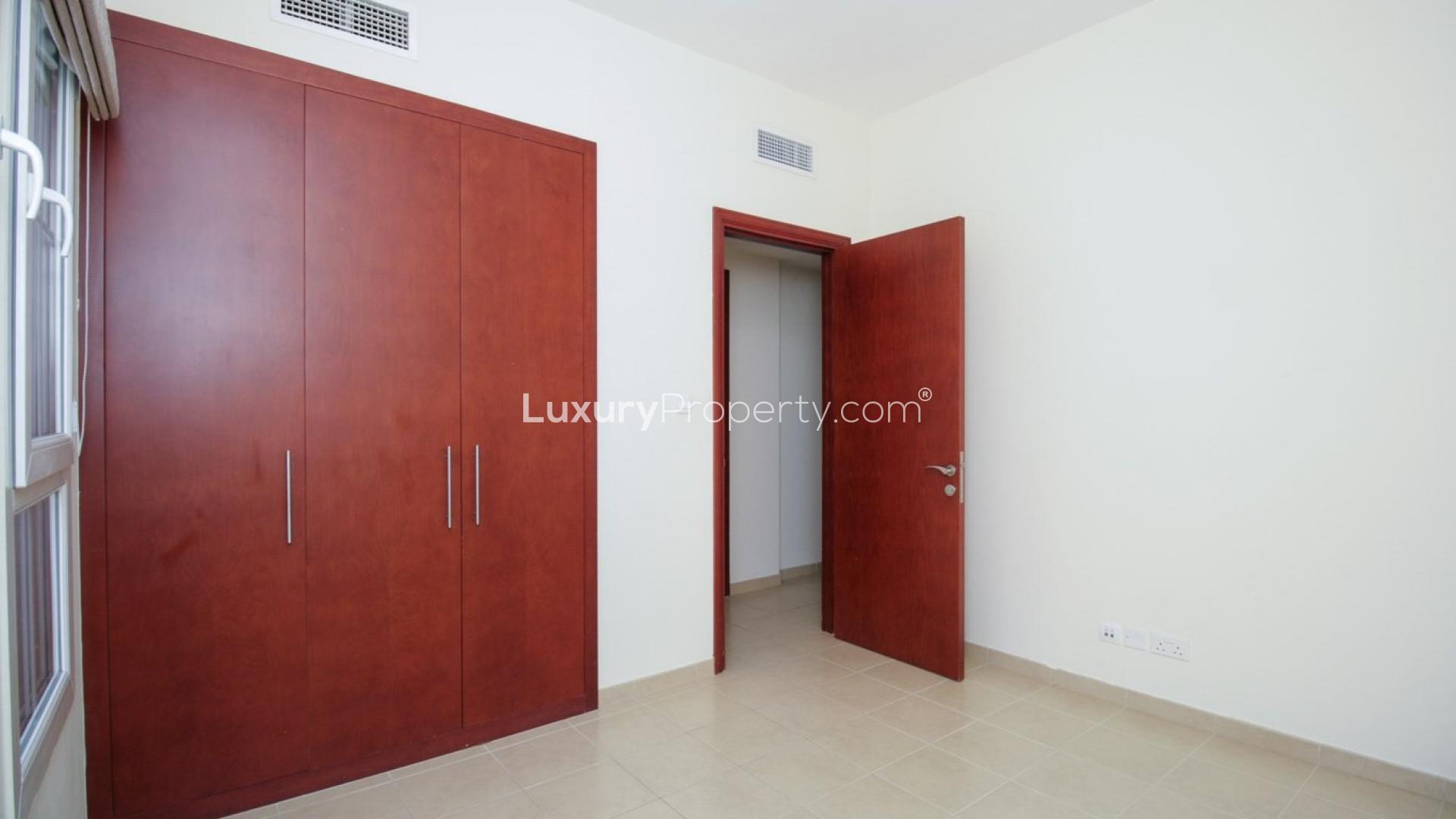 Spacious living room with tiled floor and large windows in Alma 1 townhouse, Arabian Ranches