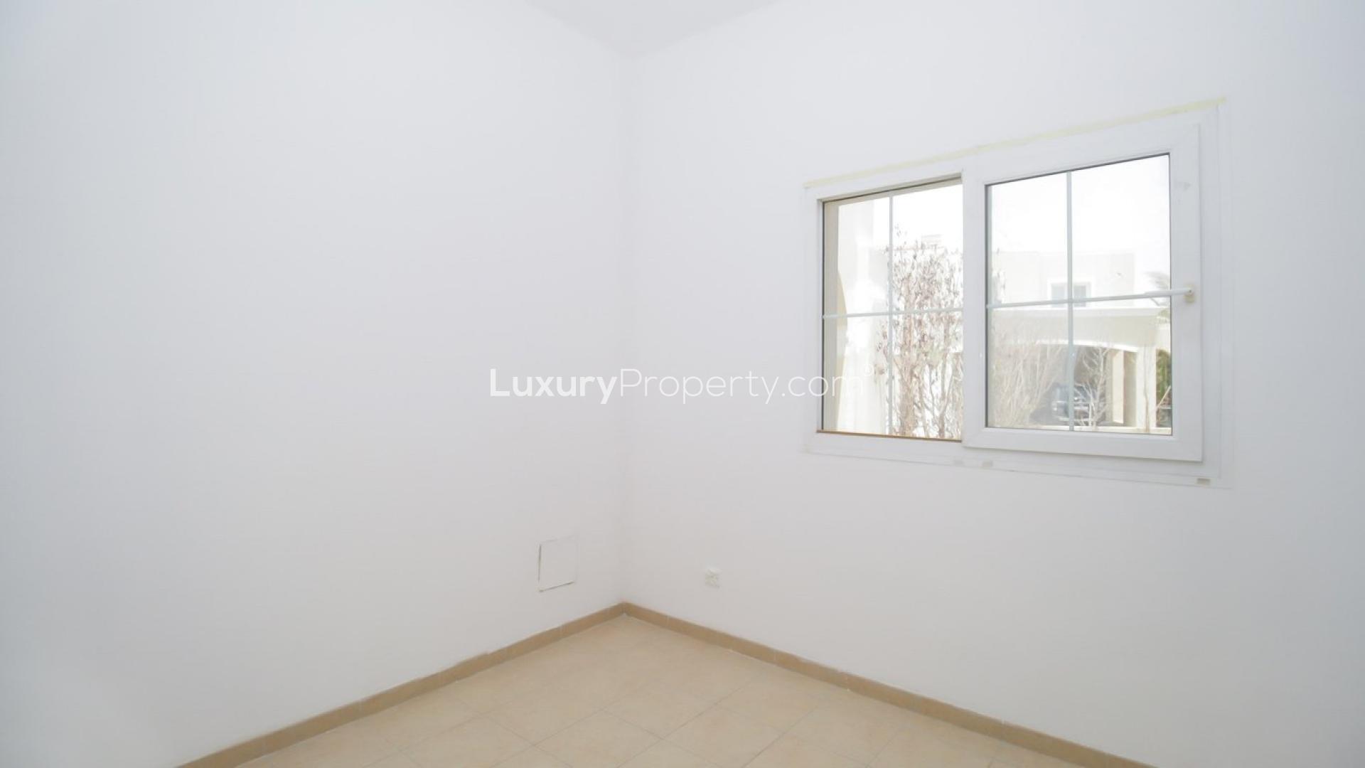 Townhouse backyard with lawn and trees in Arabian Ranches, Al Reem community