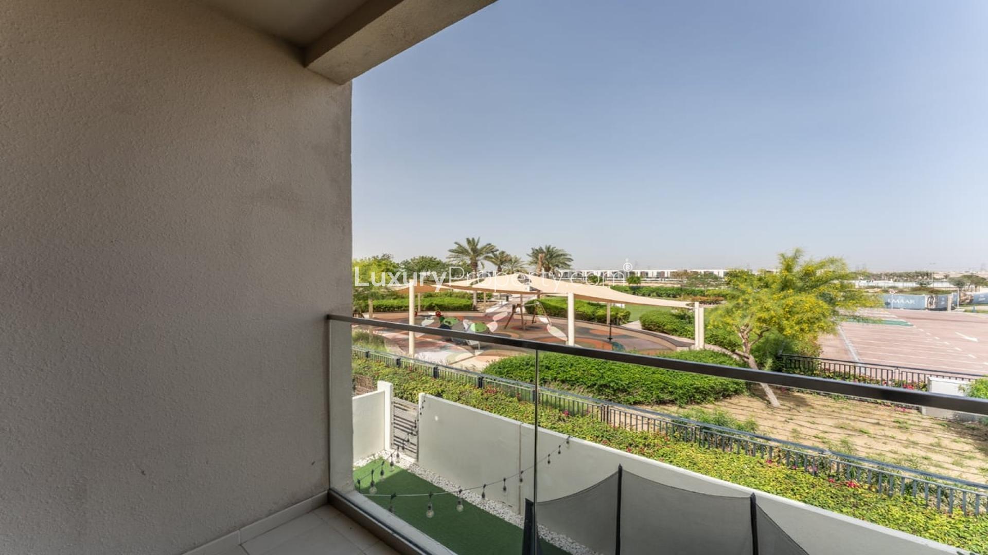 "Spacious backyard with trampoline and seating at 3-bedroom villa in Mira Oasis 1.",Balcony view of park and garden in Mira Oasis 1 townhouse, Reem community