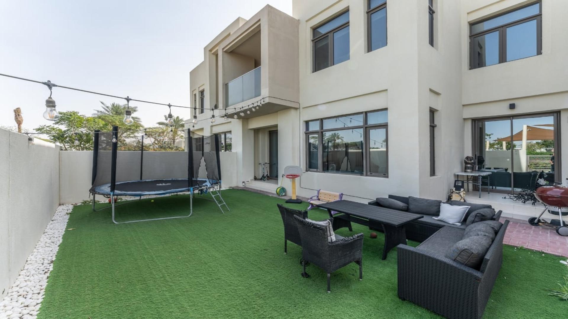 Elegant living room in 3-bedroom villa, Mira Oasis 1, Reem, with modern decor and garden view