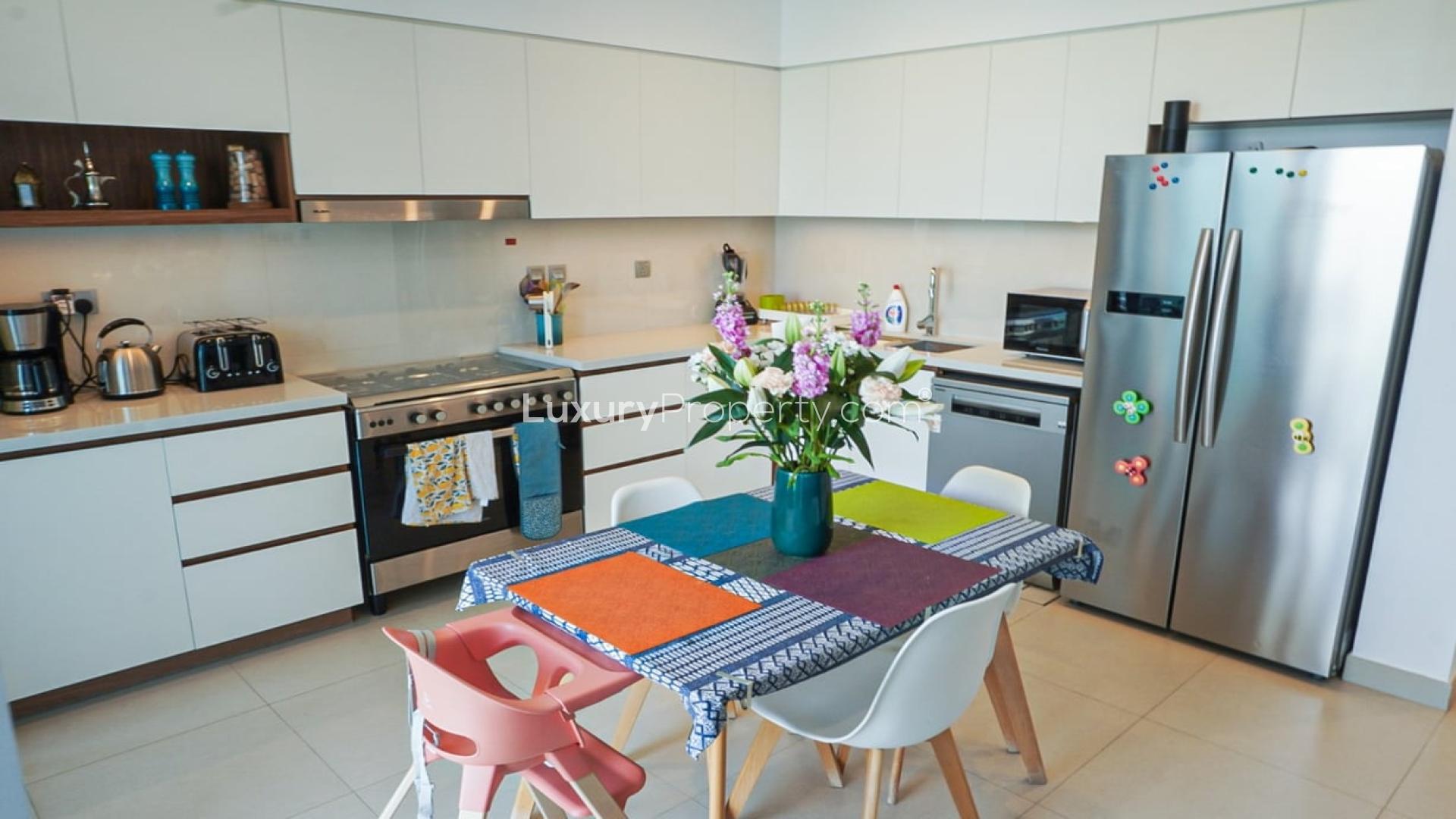 Outdoor patio with lounge chairs and artificial grass in Camelia, Arabian Ranches 2 townhouse