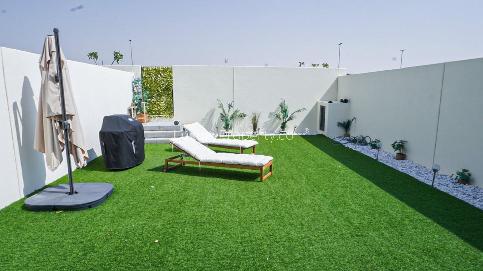 Modern kitchen in Camelia townhouse, Arabian Ranches 2, featuring dining area and stainless appliances