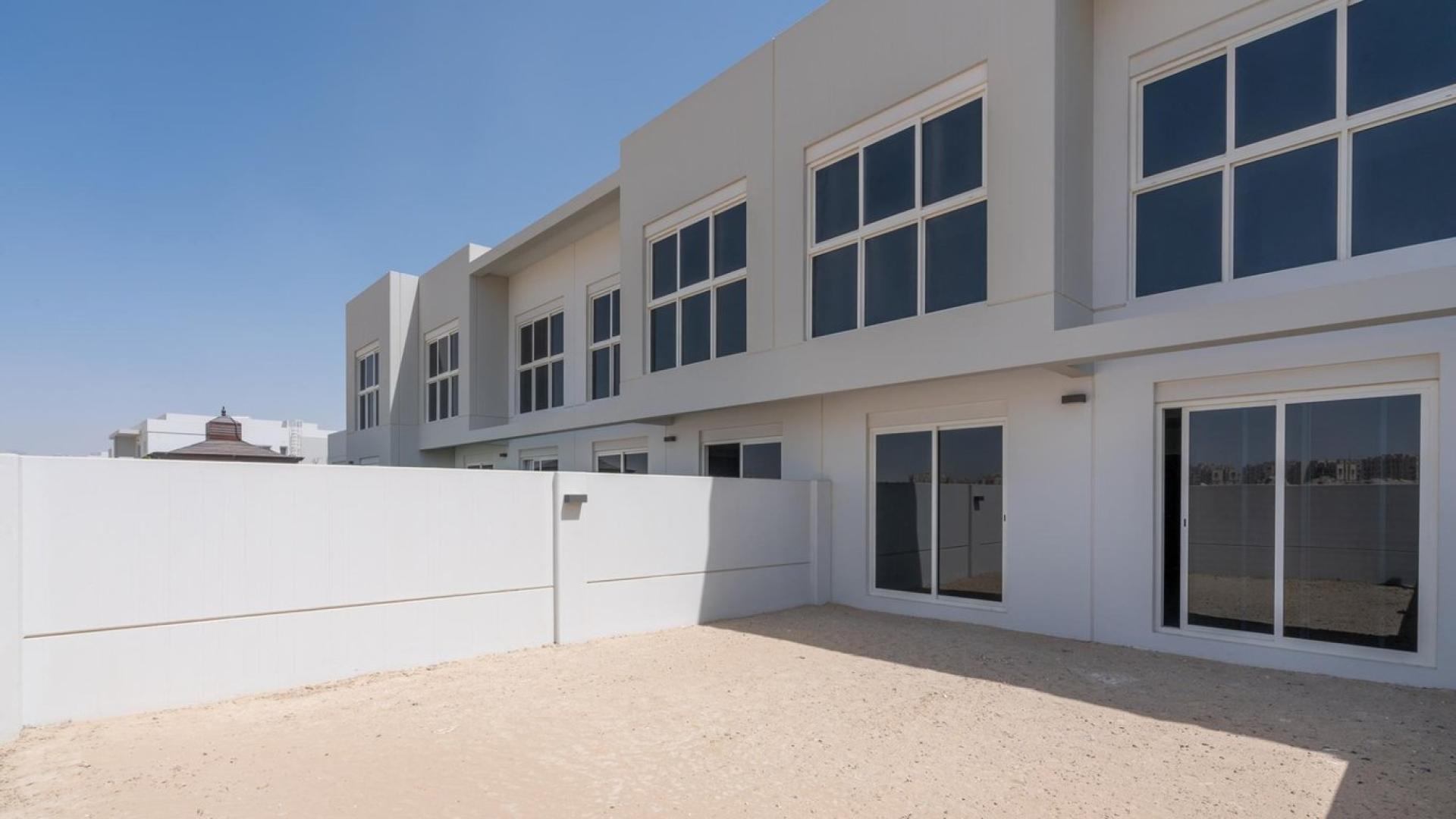 Modern open-plan living area in Arabella 3 townhouse, Mudon, featuring sleek staircase and kitchen