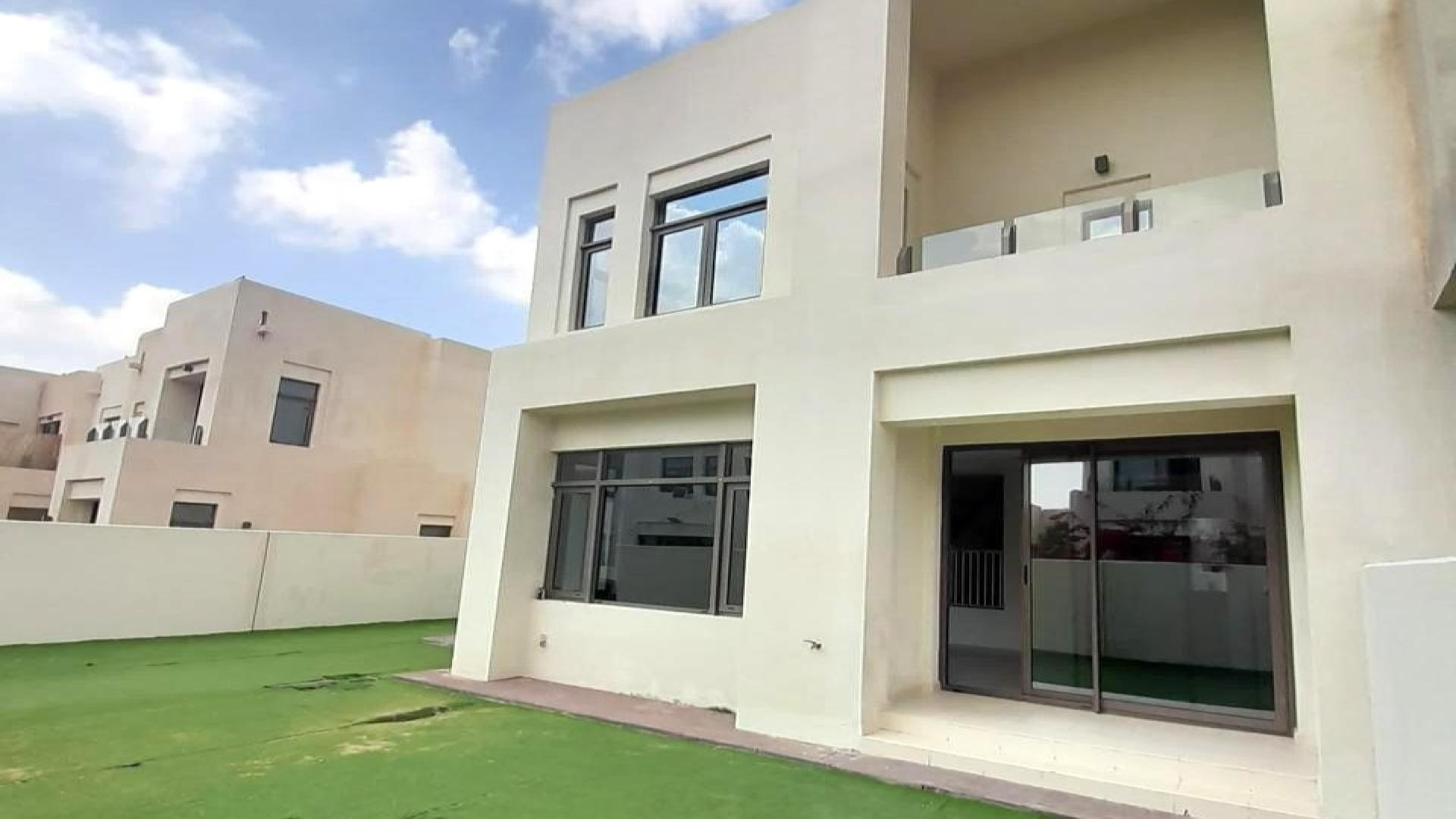 Spacious living area in Mira Oasis townhouse, featuring modern design and natural light