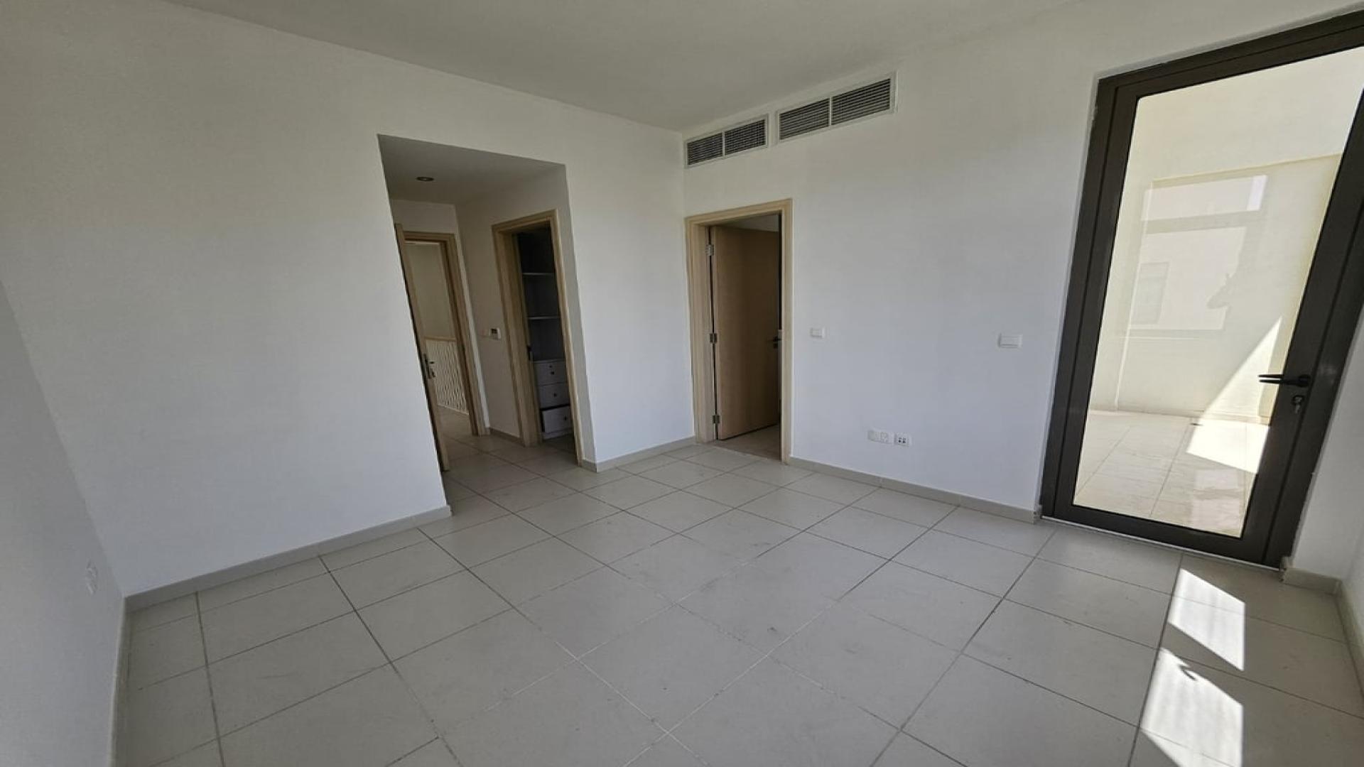 Spacious living area in Mira Oasis townhouse, featuring modern design and natural light