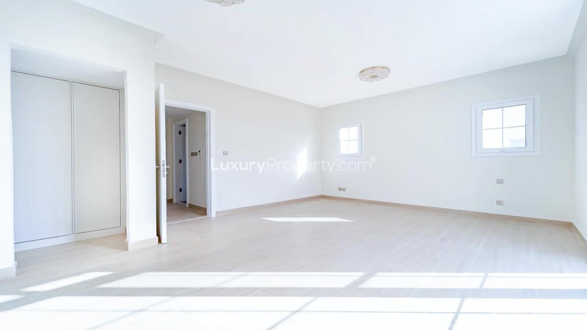 Bright empty room in Arabian Ranches 2 townhouse, featuring light wood flooring and natural light