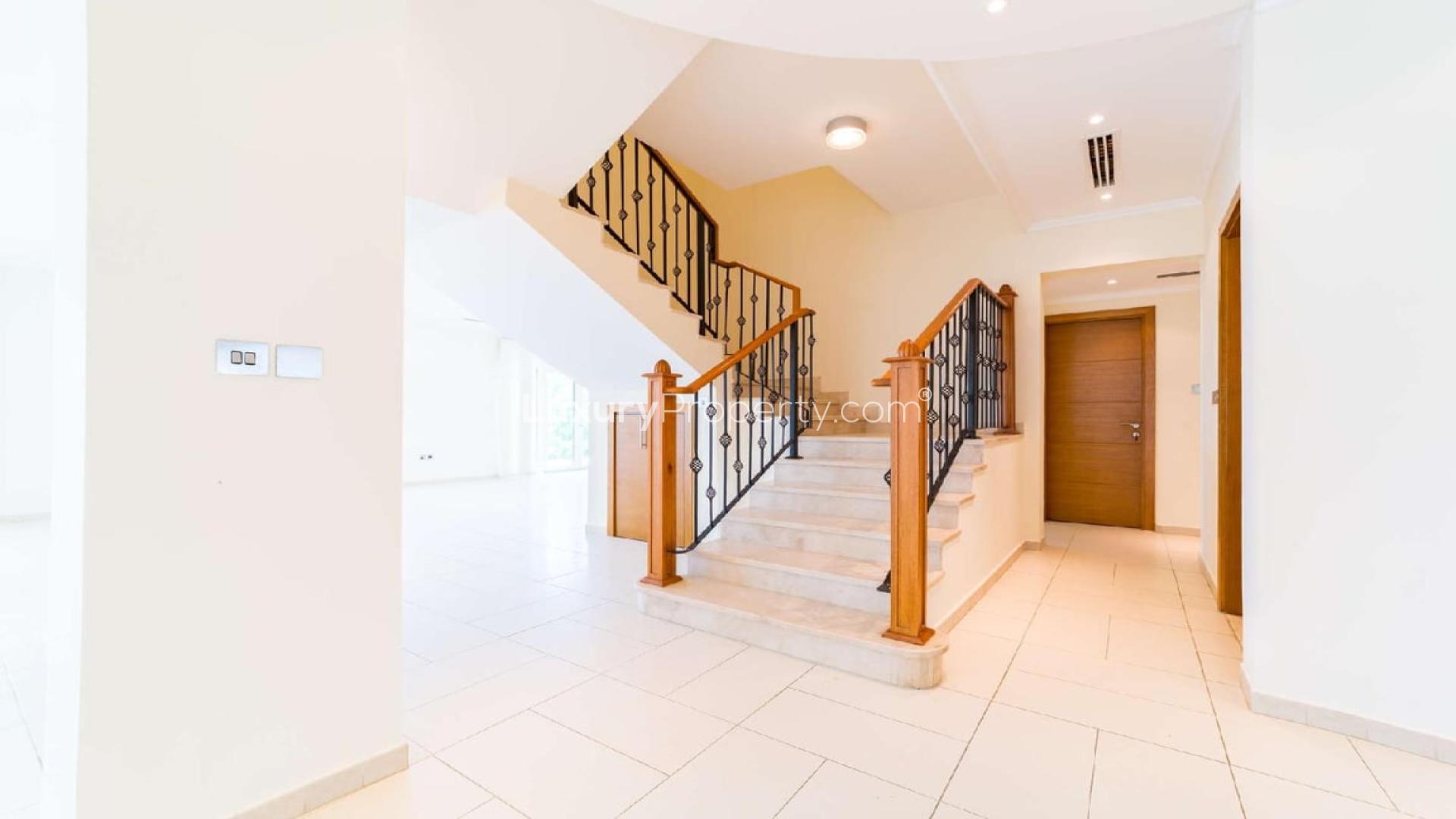 Spacious living area in Jumeirah Park villa, Legacy sub-community, featuring large windows and stairs