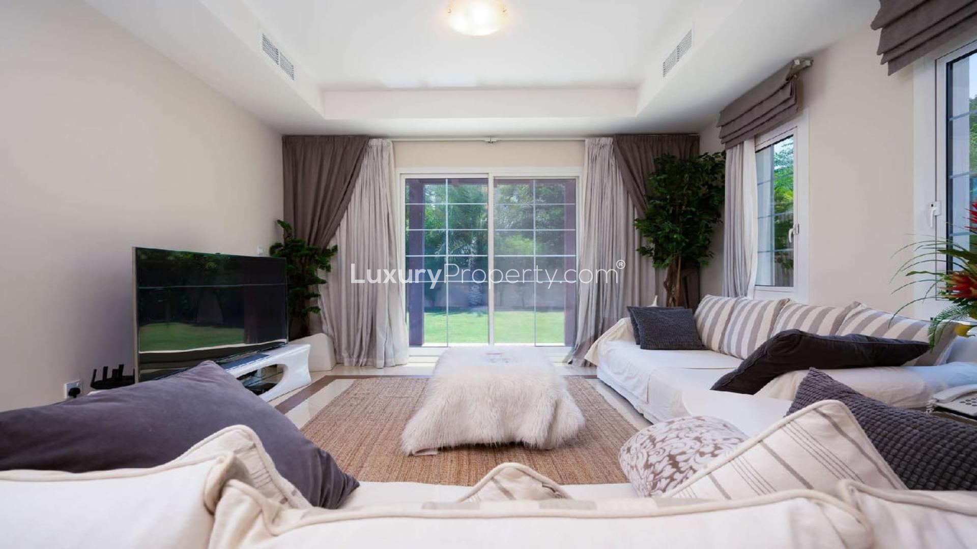 Bright living room in Rahat villa, Mudon with modern decor and garden view