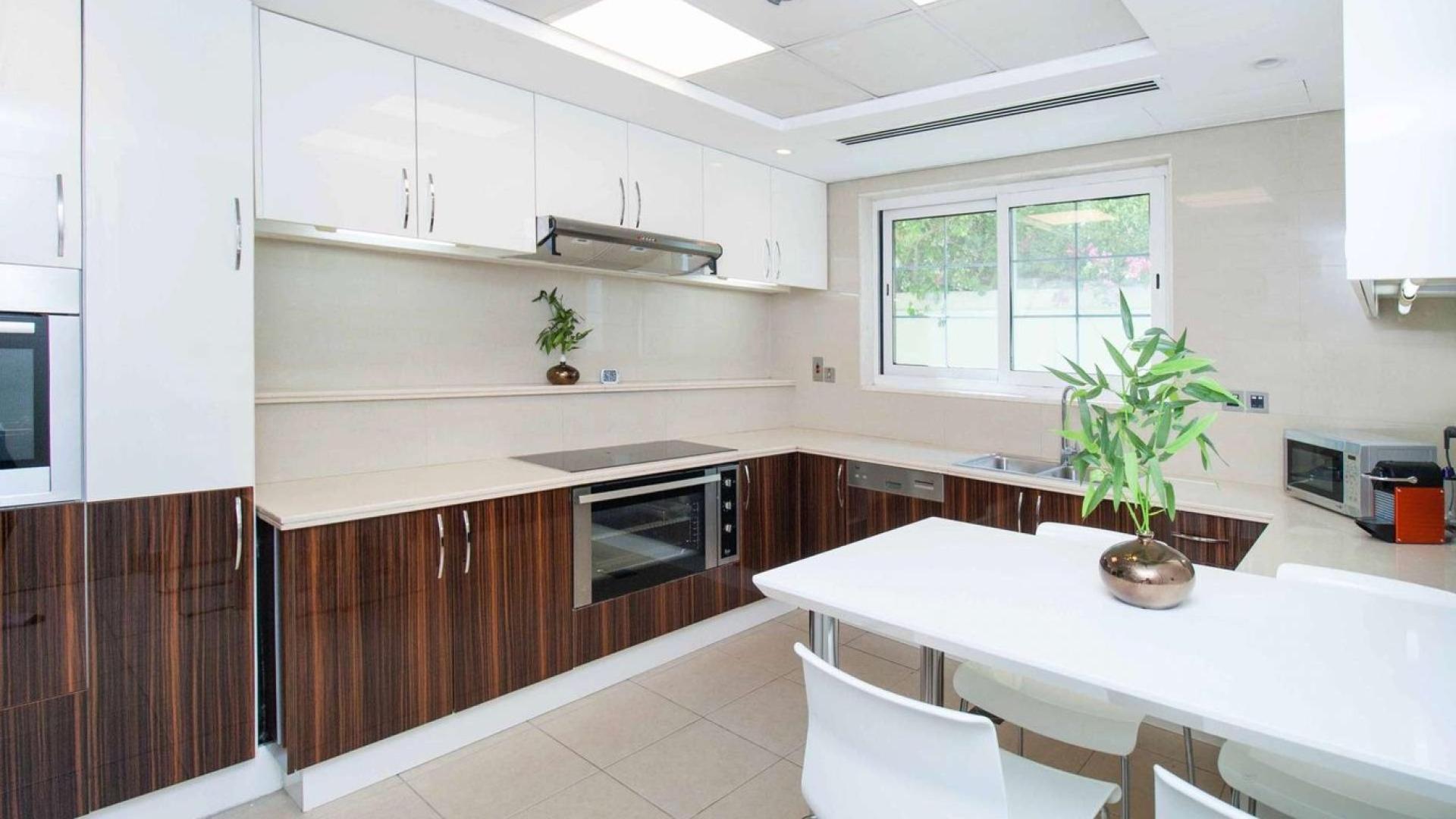 Modern kitchen with sleek cabinetry in Jumeirah Park Legacy Villa, available for rent