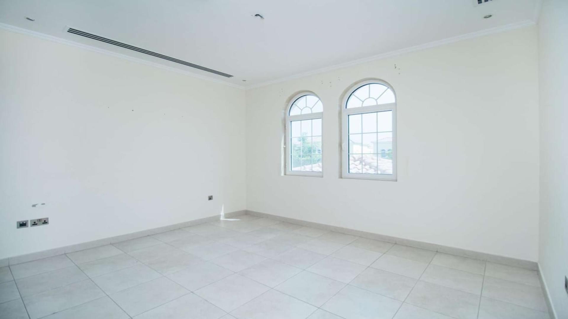 Bright, empty room in Legacy Large Villa, Jumeirah Park, with two arched windows