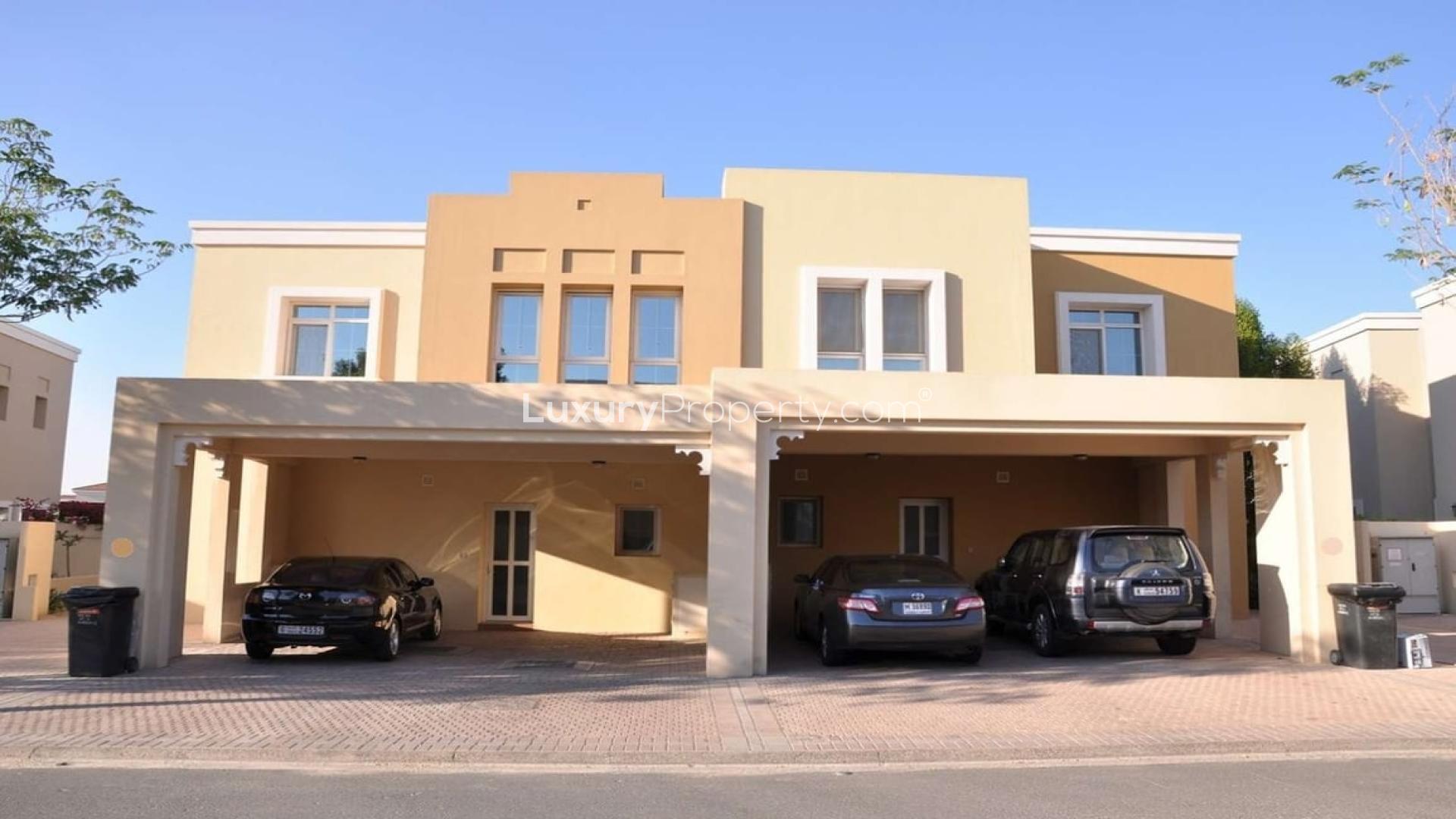 Front view of a three-bedroom villa in Arabian Ranches, Al Reem, with parking spaces