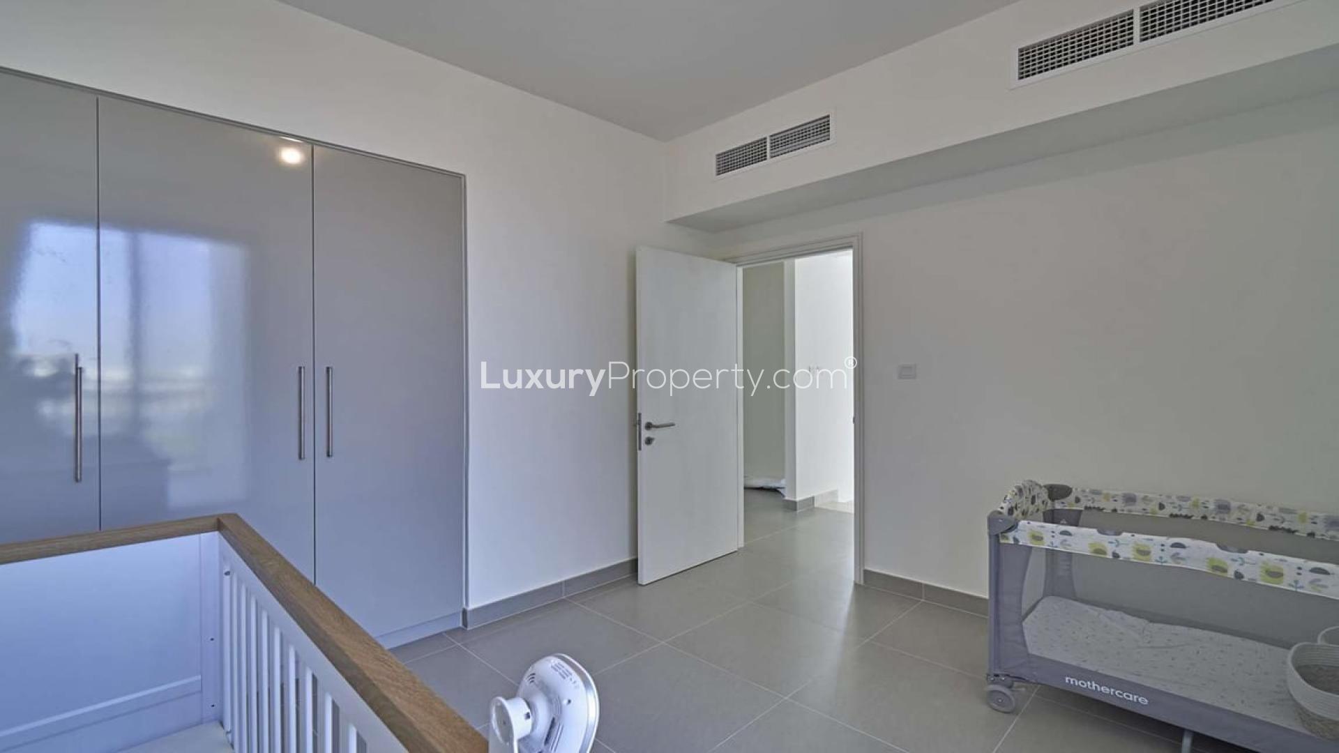 Bedroom in 3-bedroom townhouse, Maple 3, Dubai Hills Estate, featuring built-in wardrobes and crib