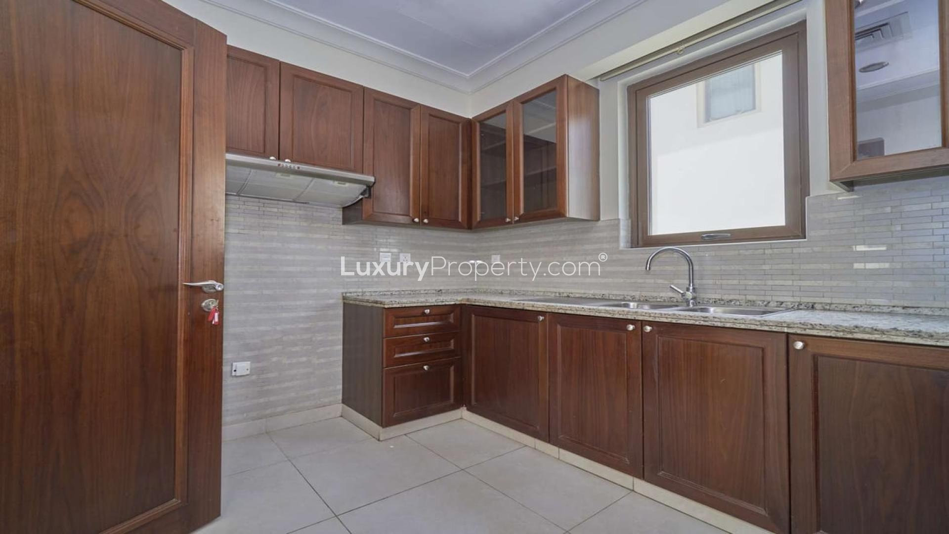 "Elegant three-bedroom villa exterior in Palma, Arabian Ranches 2, with lush landscaping.","Modern kitchen in three-bedroom villa, Arabian Ranches 2, Palma, with wooden cabinets and granite countertops.",Spacious three-bedroom villa exterior in Palma, Arabian Ranches 2, available for rent