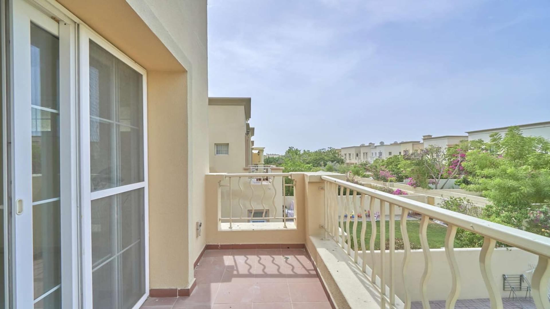 Balcony view from Springs 11 townhouse overlooking landscaped garden, available for rent