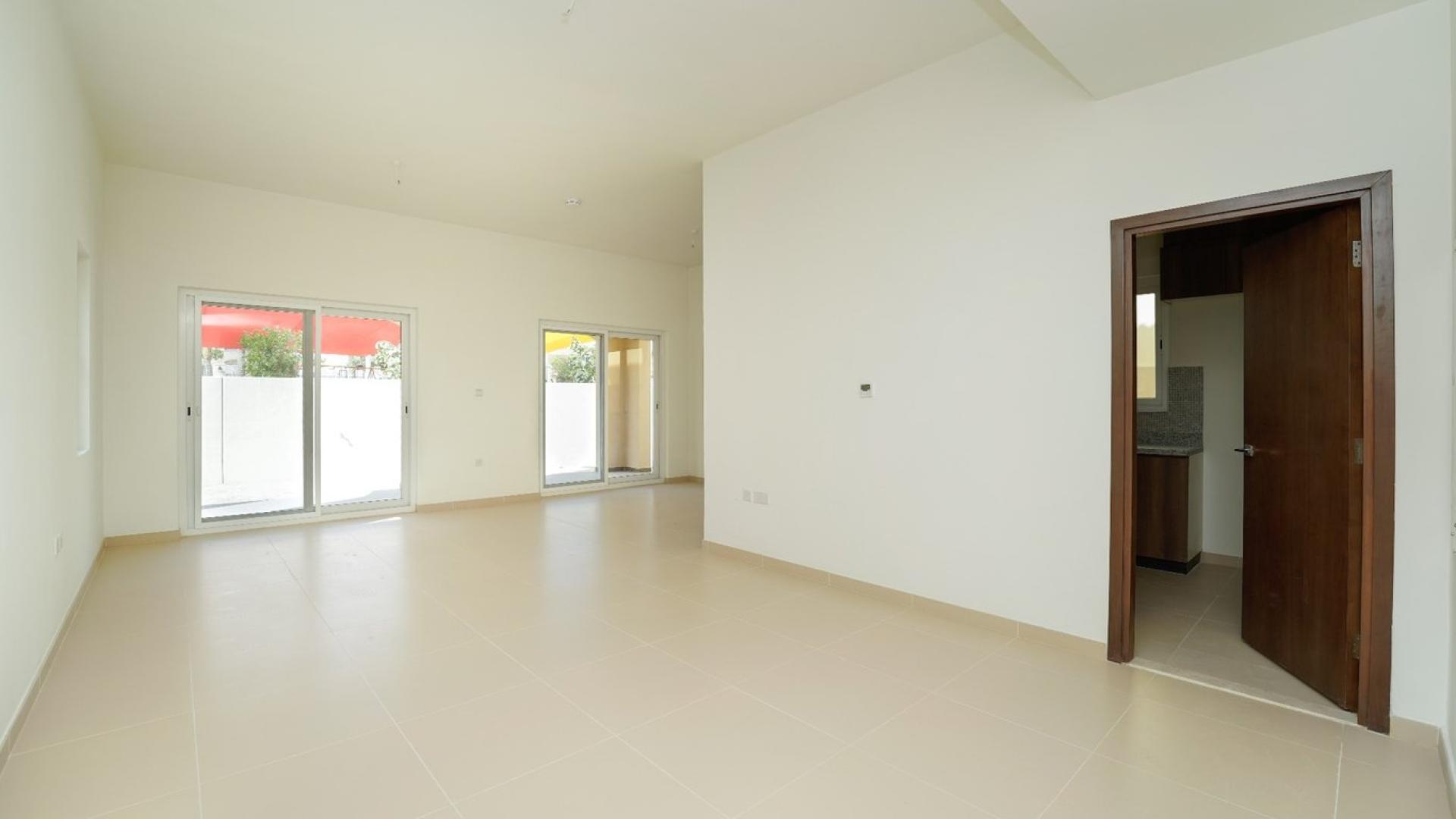 Three-bedroom villa in Villanova, Dubai Land with playground view and lush greenery