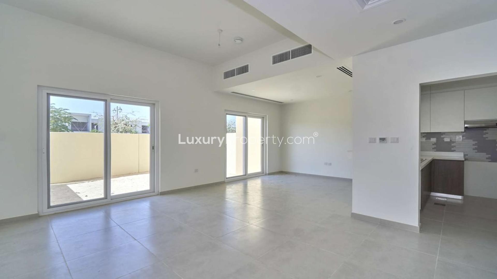 Spacious living area in Villanova villa for rent, Dubai Land, with modern kitchen view