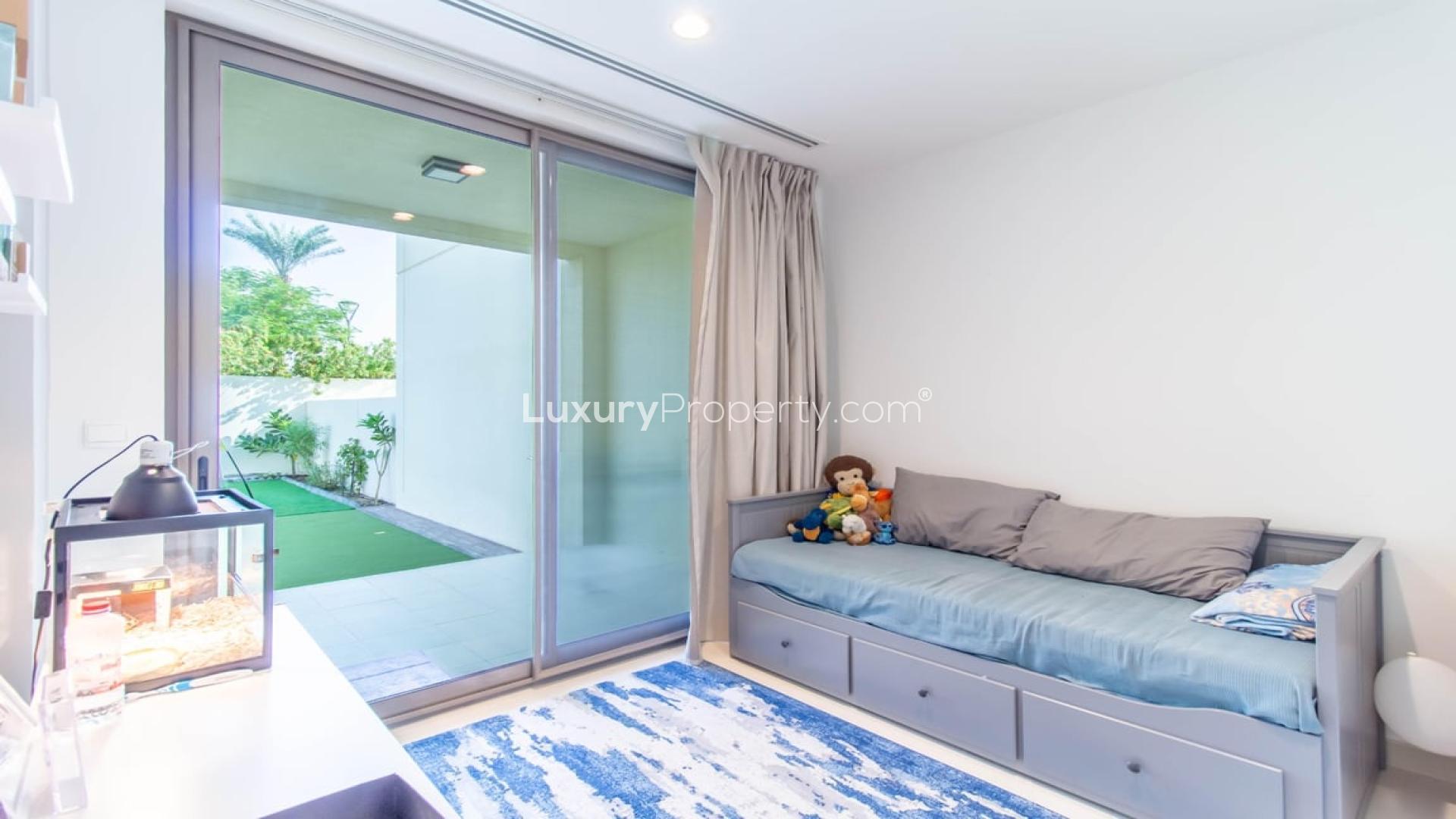 N/A,Modern Mira Oasis villa bedroom with garden view, featuring cozy bed and bright decor