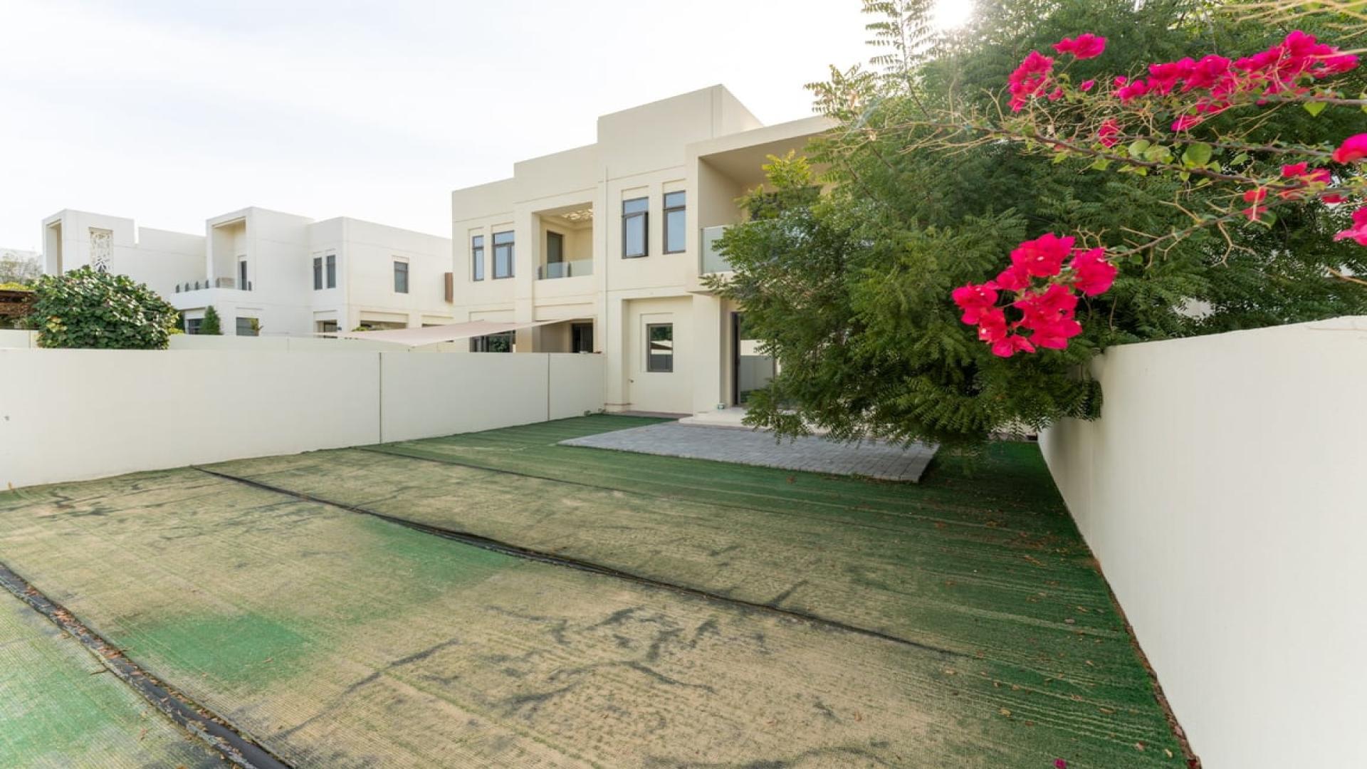 Modern villa living room in Mira Oasis, featuring cozy seating and dining area