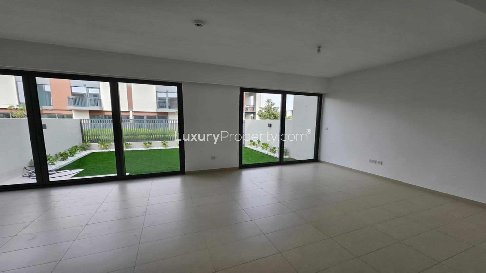 Spacious living room with garden view in Cherrywoods villa, Dubai Land, for rent