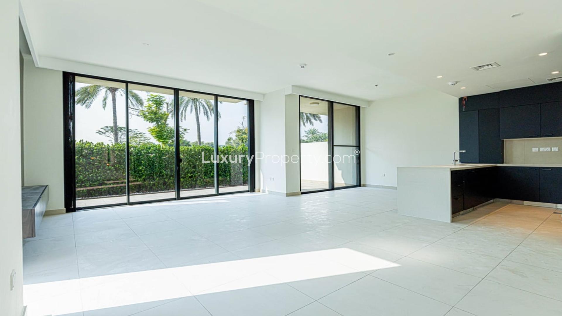 N/A,Stylish open-plan kitchen and living area in Dubai Hills Estate villa with garden views