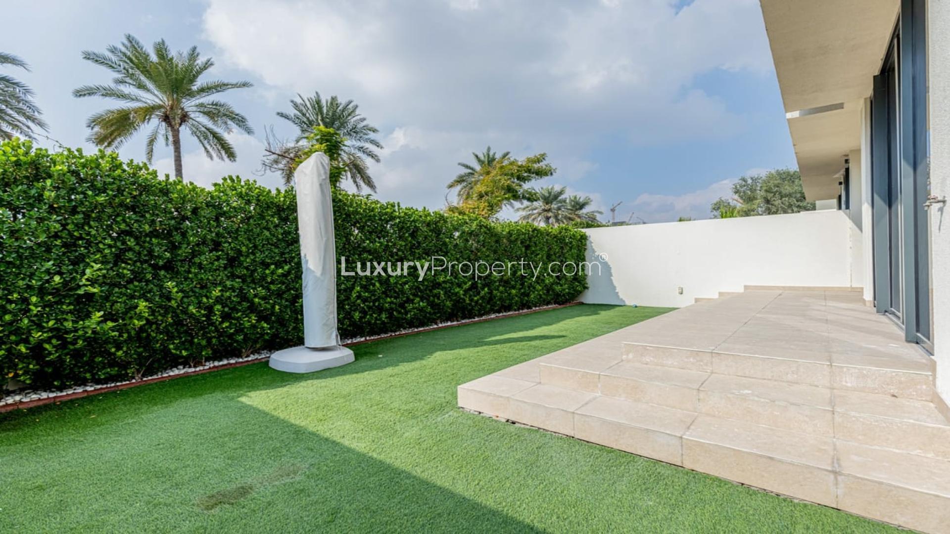 Open-plan living area with modern kitchen in Dubai Hills Estate villa for rent