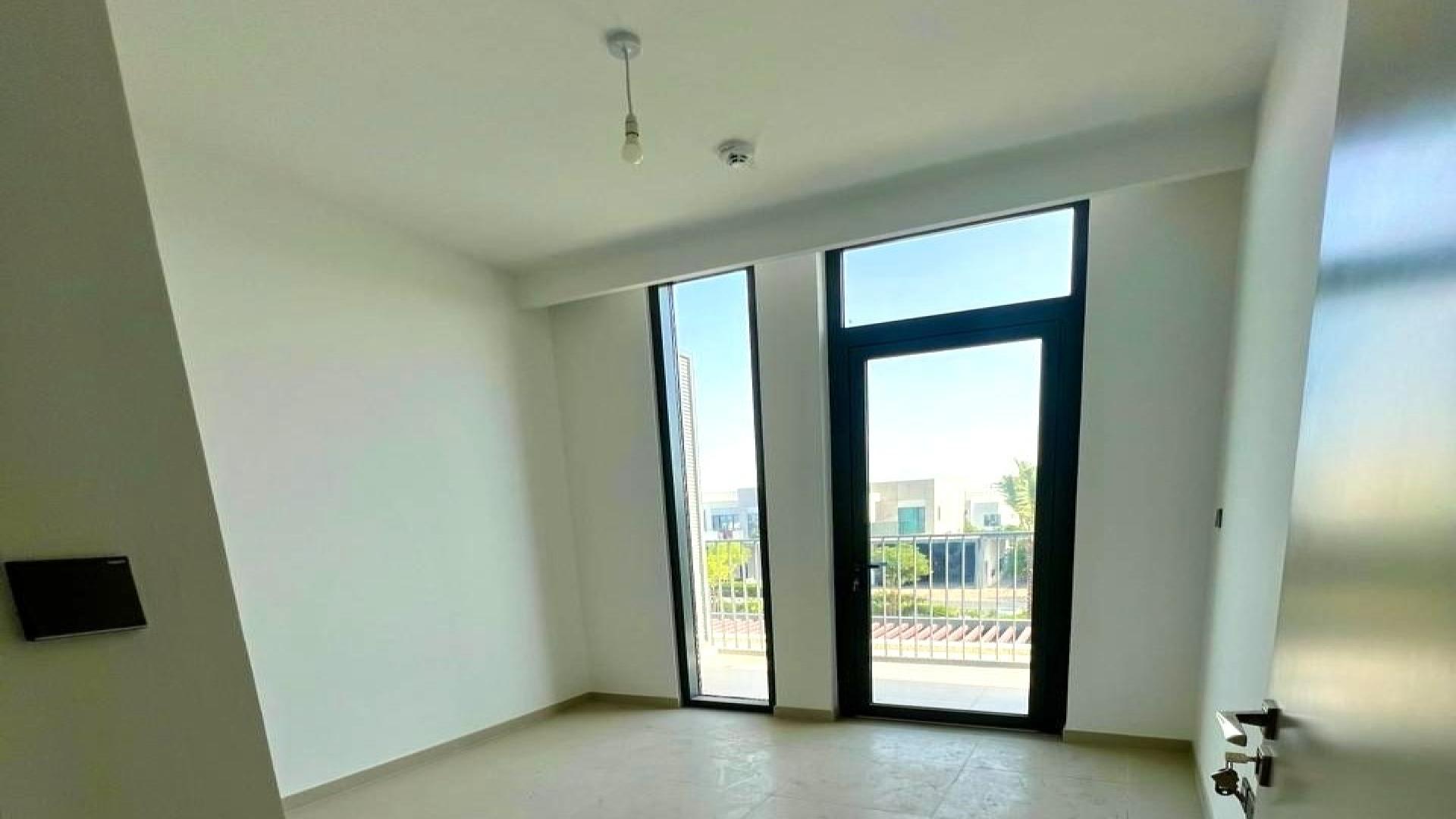 Vacant villa room with large window and park views in Arabian Ranches 3, Sun community