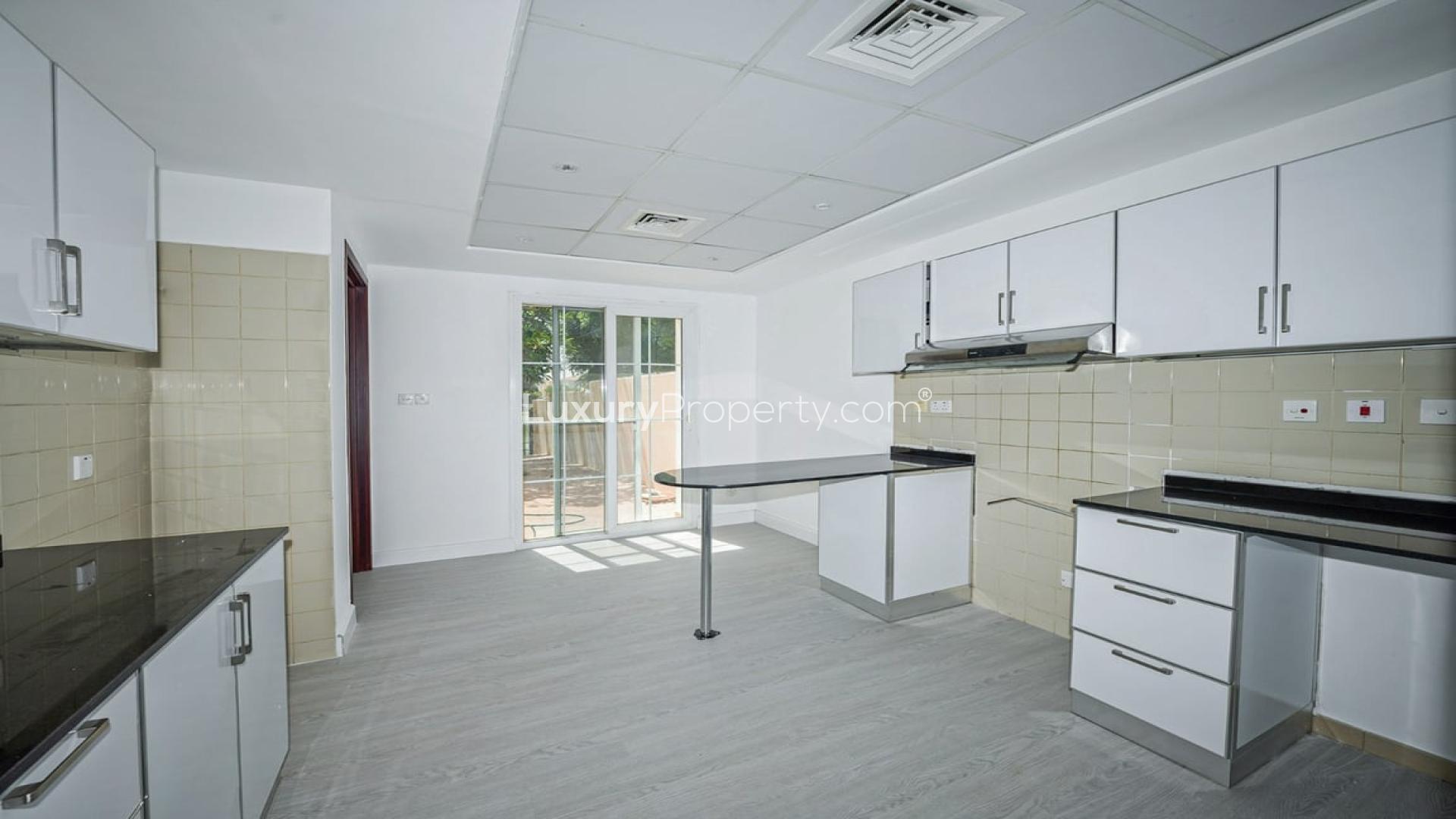 "Spacious living room with large windows in Al Reem villa, Arabian Ranches, for rent.",Upgraded kitchen in Al Reem villa, Arabian Ranches, featuring modern cabinets and countertops