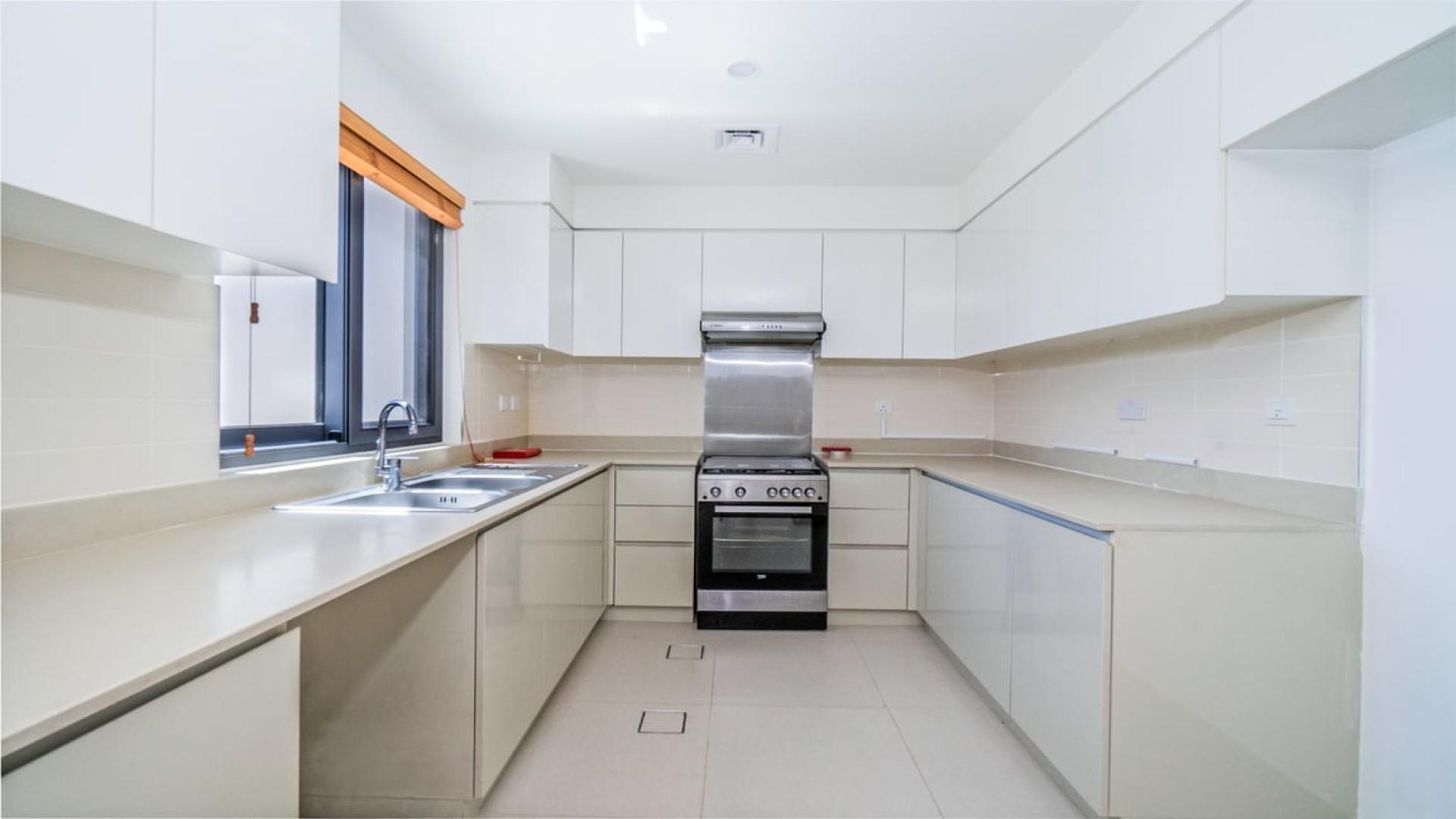 Spacious living area in Maple villa, Dubai Hills Estate with large windows and modern fixtures