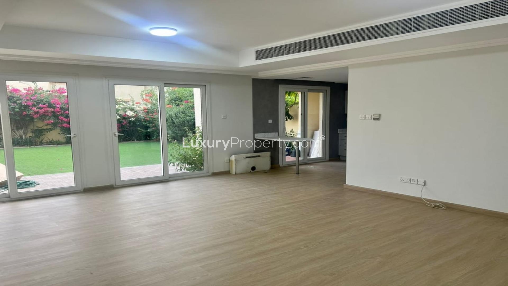 Upgraded Springs 12 villa garden with lush greenery and vibrant flowers in Dubai