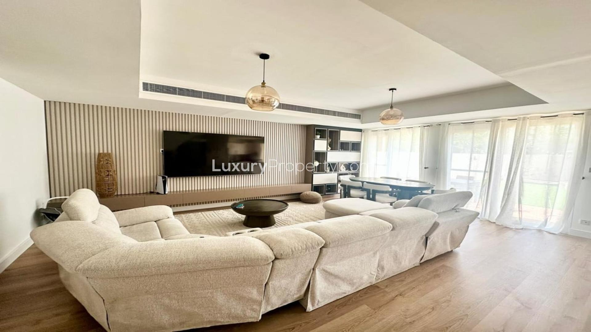 Luxurious living room in 3-bedroom villa, Springs 4, Dubai, with modern decor and ample seating