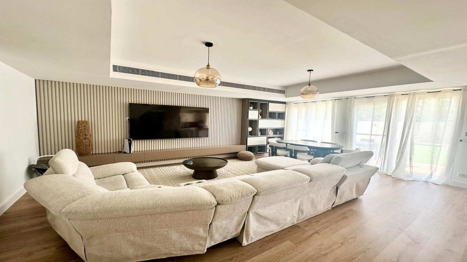 Luxurious living room in 3-bedroom villa, Springs 4, Dubai, with modern decor and ample seating
