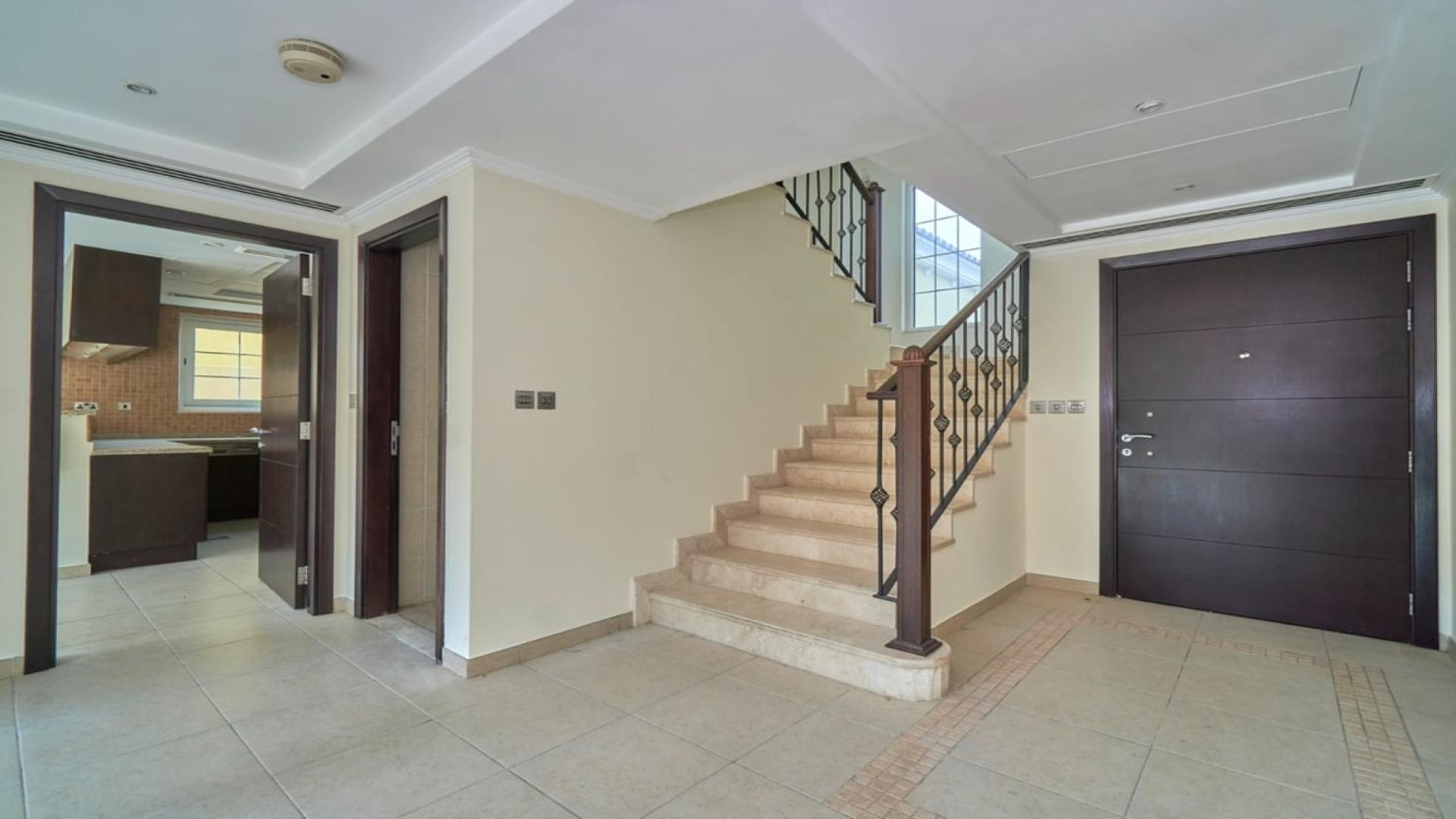 Entrance of spacious 3-bedroom Legacy Villa in Jumeirah Park, Dubai, with garden view