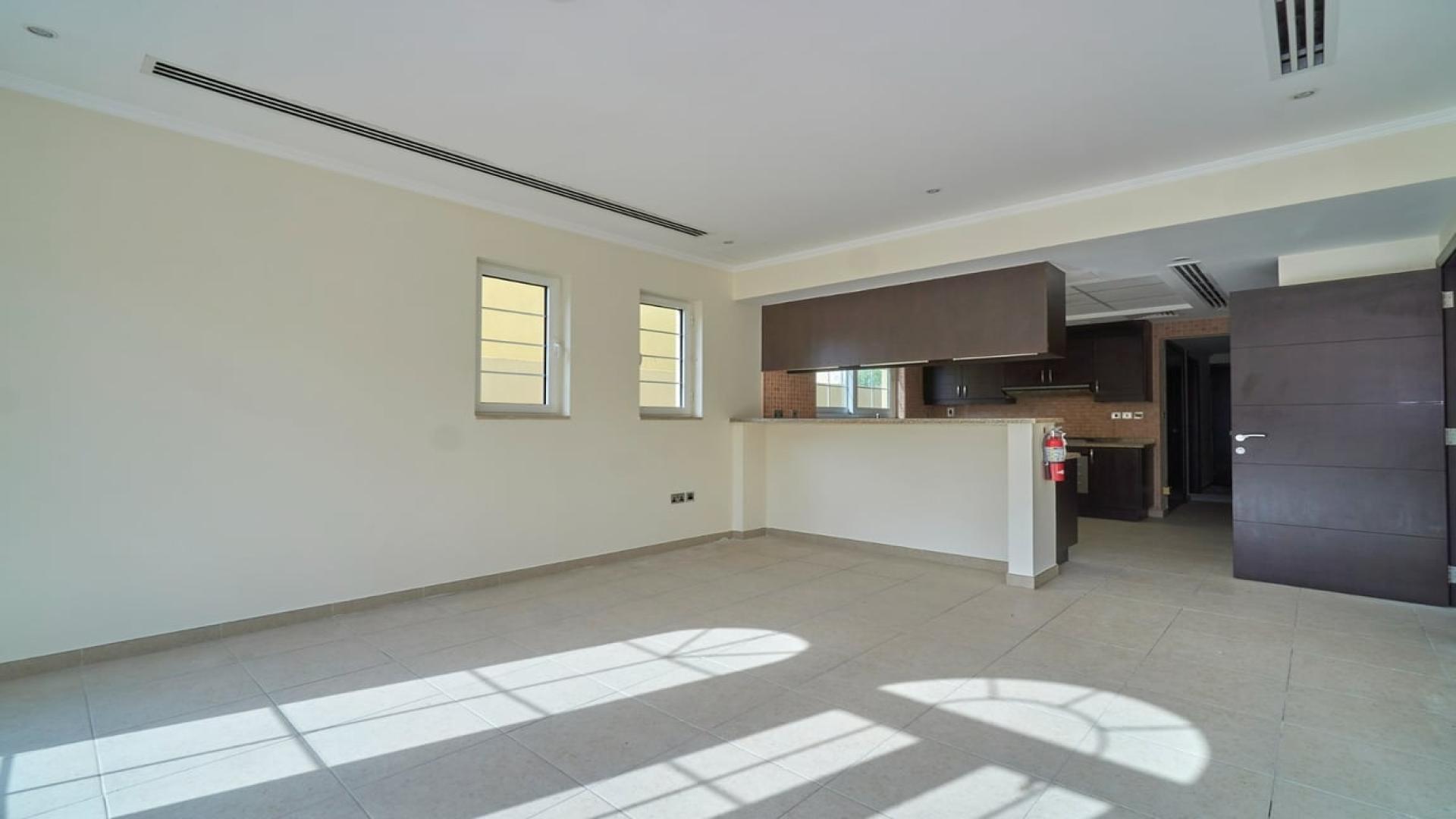Bright living room in Jumeirah Park Legacy villa for rent, featuring large windows and tiles
