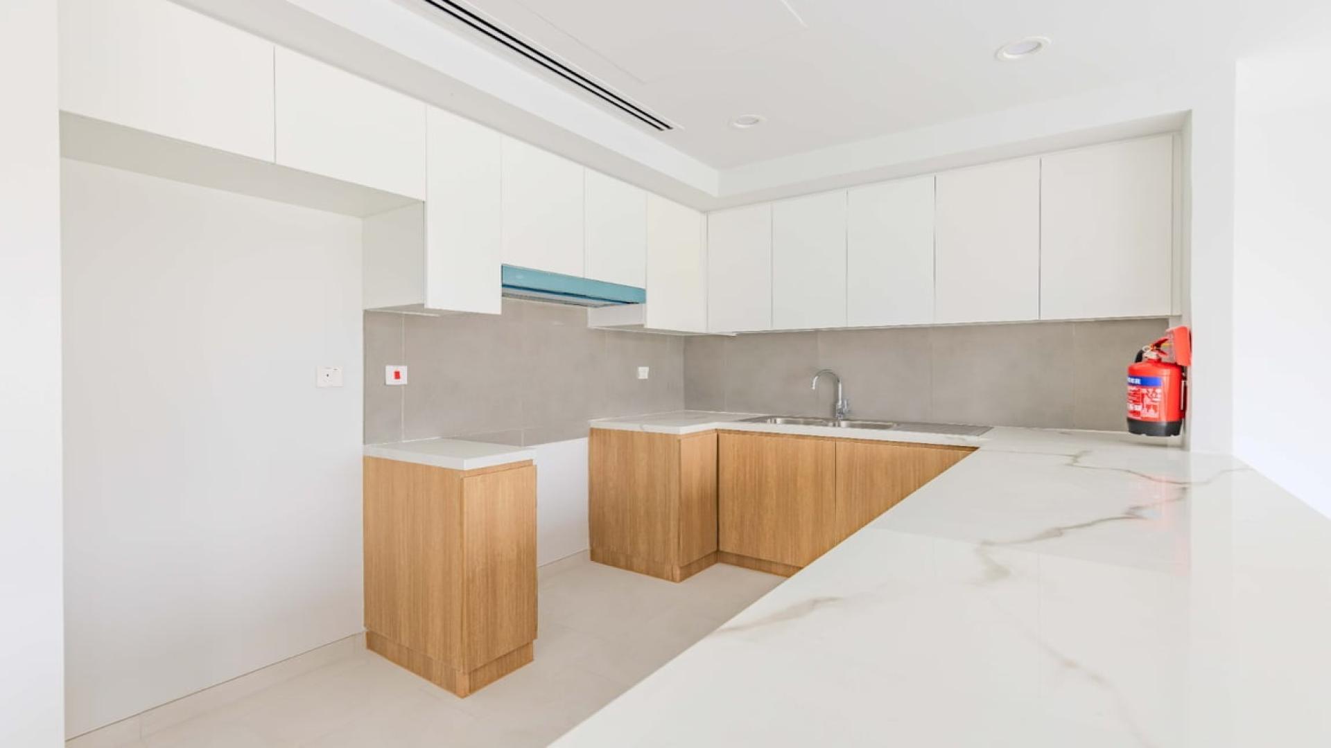 Modern open-plan living area in 3-bedroom villa, La Rosa, Dubai Land, with garden view